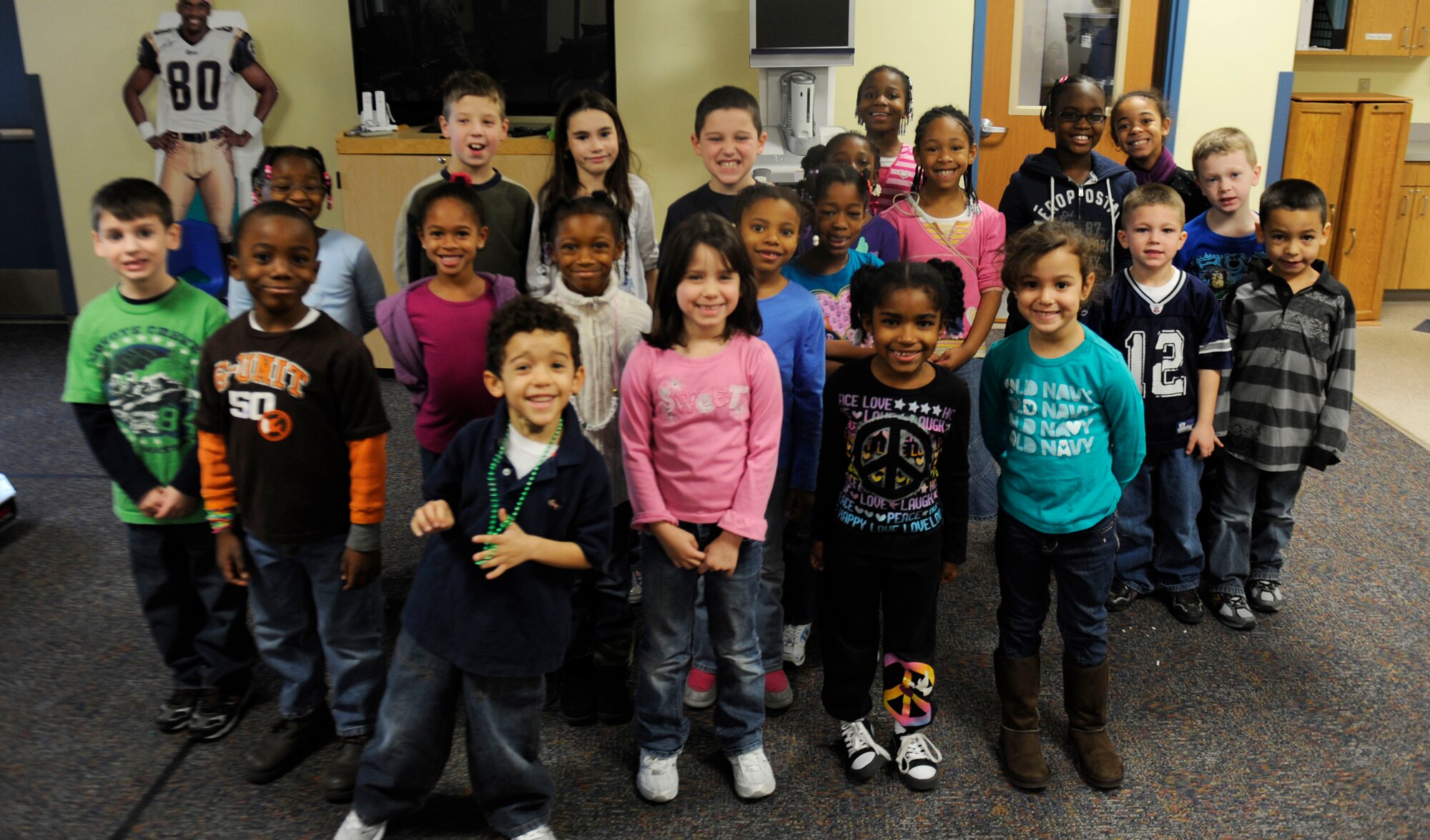 Children at the Scott Air Force Base Youth Center pose for a group photo Dec. 29. The Youth Center invited the Public Affairs team to come visit and talk about their job while also giving the children some hands on learning with the equipment. (U.S. Air Force photo/Staff Sgt. Ryan Crane)