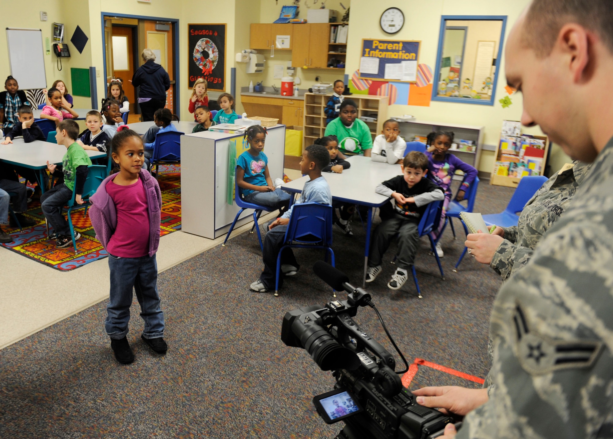 Jaden Galloway, 6, gives an interview to the 375th Public Affairs news team while at the Scott Air Force Base Youth Center Dec. 29. The Youth Center invited the Public Affairs team to come visit and talk about their job while also giving the children some hands on learning with the equipment. (U.S. Air Force photo/Staff Sgt. Ryan Crane)