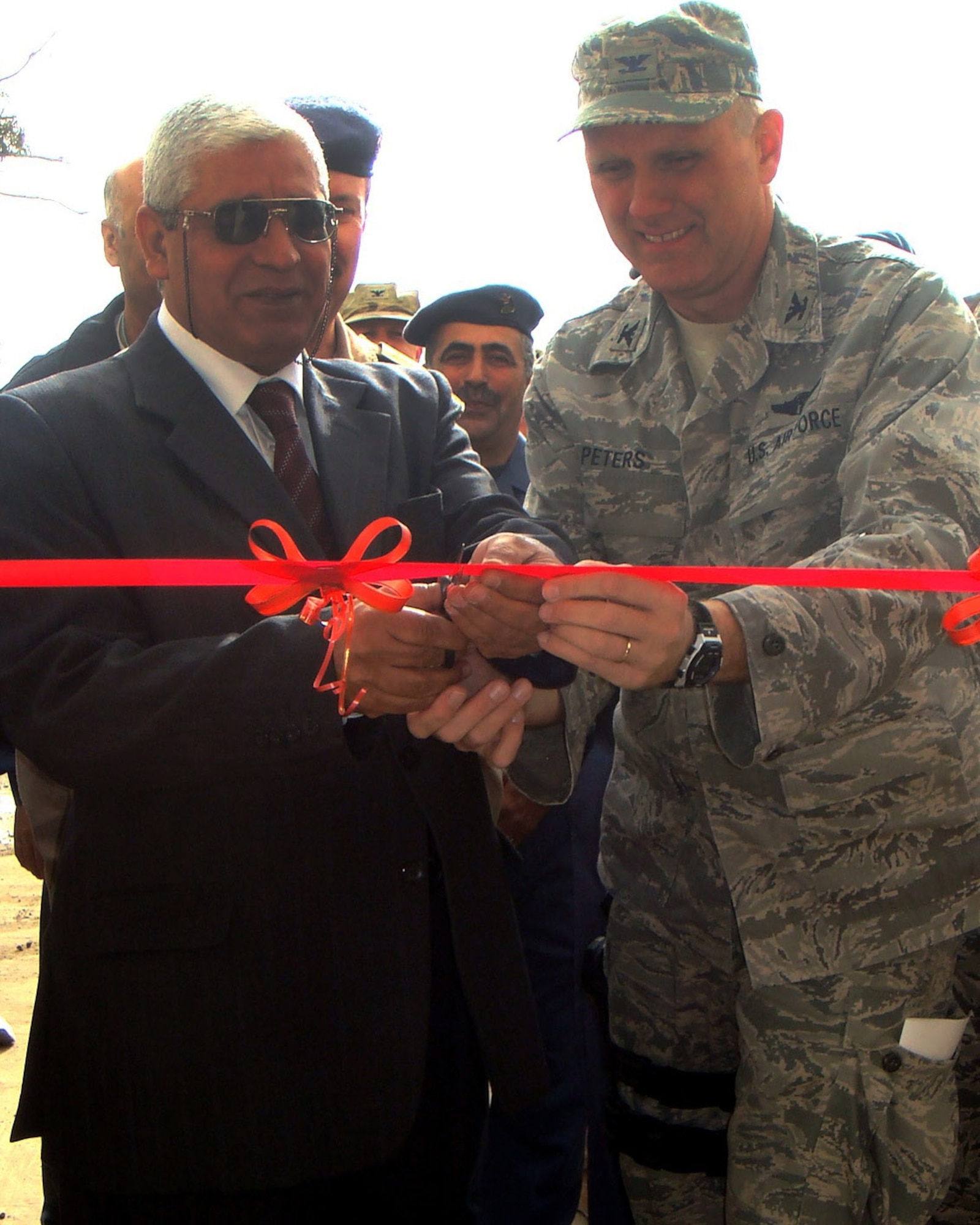 Iraqi air force Brig. Gen. Salah (left) and Col. Gordon Peters cut the ribbon for a new medical facility Dec. 11, 2010, at New Al-Muthana Air Base, Iraq. The facility has state-of-the-art equipment, technology and the capability to house patients for extended periods. General Salah is the Iraq Air Force Surgeon General and Colonel Peters is the Iraq Training and Advising Mission Surgeon General. U.S. Air Force photo)