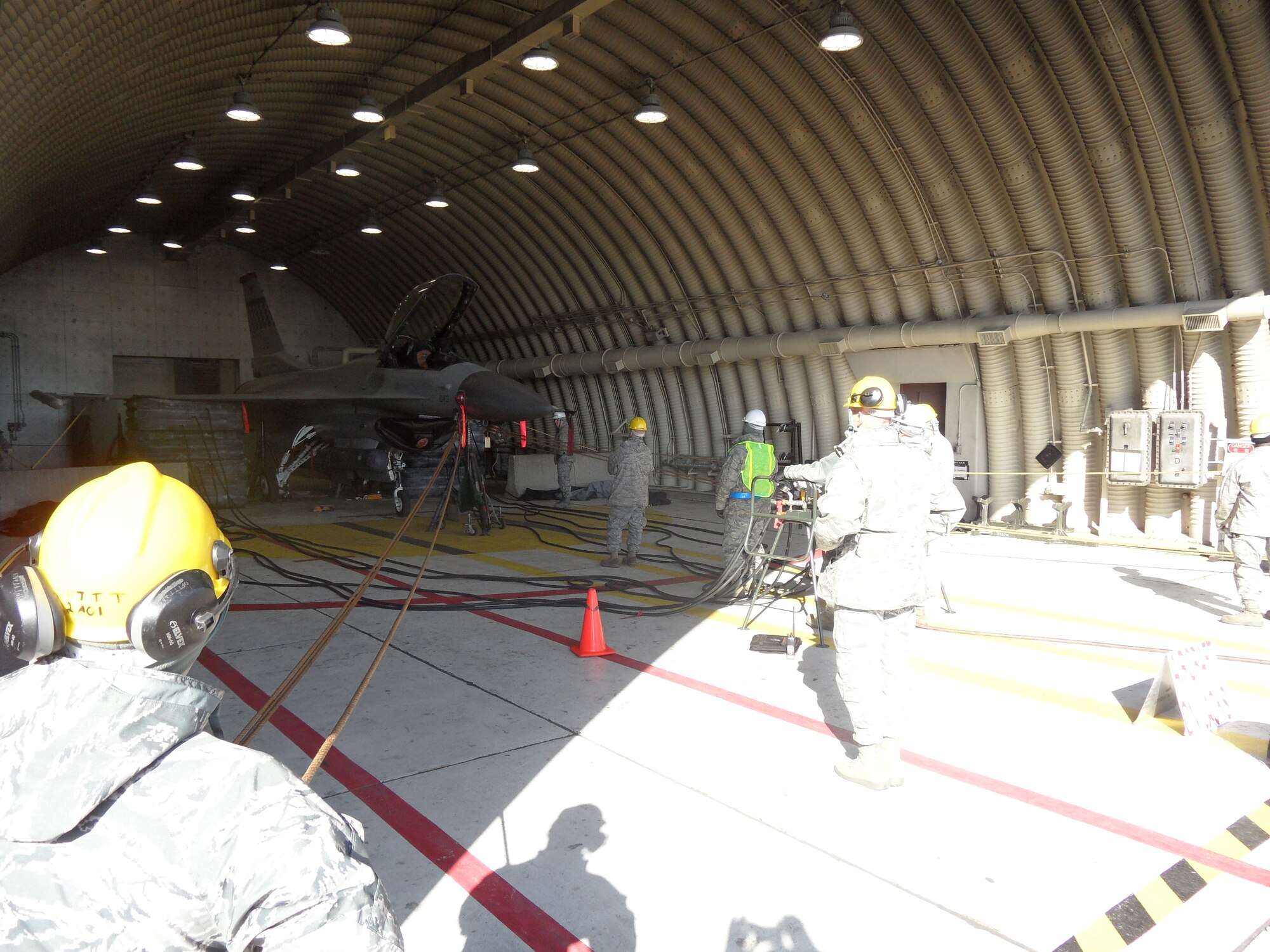 51st Maintenance Squadron Transient Alert Crash Recovery team members conduct an airbag lift operation inside Hanger 18L at Osan AB Dec. 11. (U.S. Air Force photo/Tech. Sgt. Kasey Lynch)