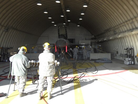 51st Maintenance Squadron Transient Alert Crash Recovery team members conduct an airbag lift operation inside Hanger 18L at Osan AB Dec. 11. (U.S. Air Force photo/Tech. Sgt. Kasey Lynch)