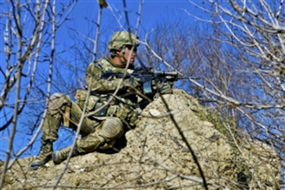 U.S. Army Spc. Mark E. Fielding provides security for Afghan National Security Forces on day five of a six-day dismounted operation in Logar province, Afghanistan, Dec. 23, 2010. Fielding is assigned to the 10th Mountain Division's Company C, 2nd Battalion, 30th Infantry Regiment, 4th Brigade Combat Team, Task Force Storm.