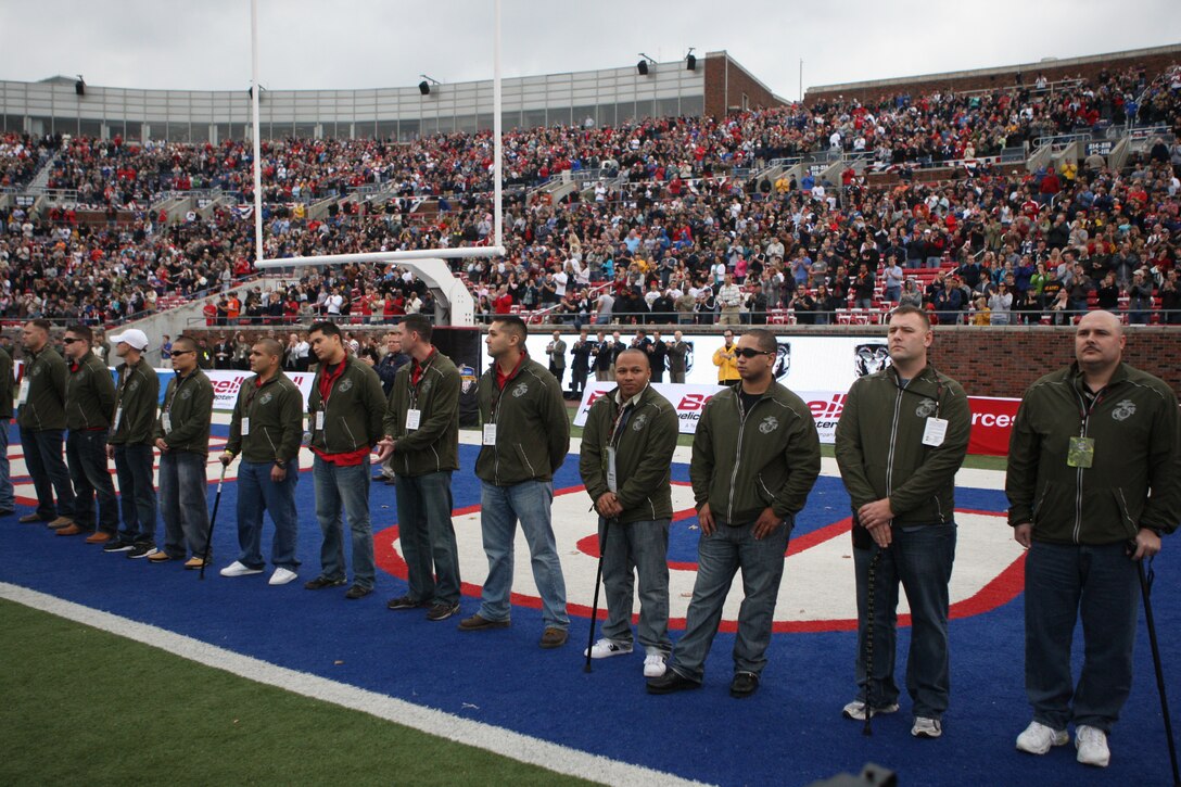 Marines representing part of Wounded Warrior Battalion - East from Marine Corps Base Camp Lejeune and Brooke Army Medical Center aboard Fort Sam Houston, Texas, stand in the end zone of the Armed Forces Bowl 2010 post-season college football game to be recognized by the thousands of fans in the Gerald J. Ford Stadium in Dallas, Dec. 30. The trip to Dallas was a two-part event, where not only were the wounded warriors able to attend a football game and be recognized, but also distribute resumes to various big-name corporations for job opportunities after they leave the service.