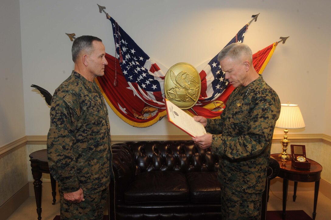 General James F. Amos, commandant of the Marine Corps, reads the promotion warrant for then Maj. Gen. Robert E. Milstead, Jr., who was promoted to his current rank of lieutenant general on Dec. 30 at Headquarters Marine Corps. He was nominated, confirmed and promoted in the span of one month before assuming his responsibilities as deputy commandant, Manpower and Reserve Affairs on Jan. 3. (U.S. Marine Corps photo by Lance Cpl. James B. Purschwitz)