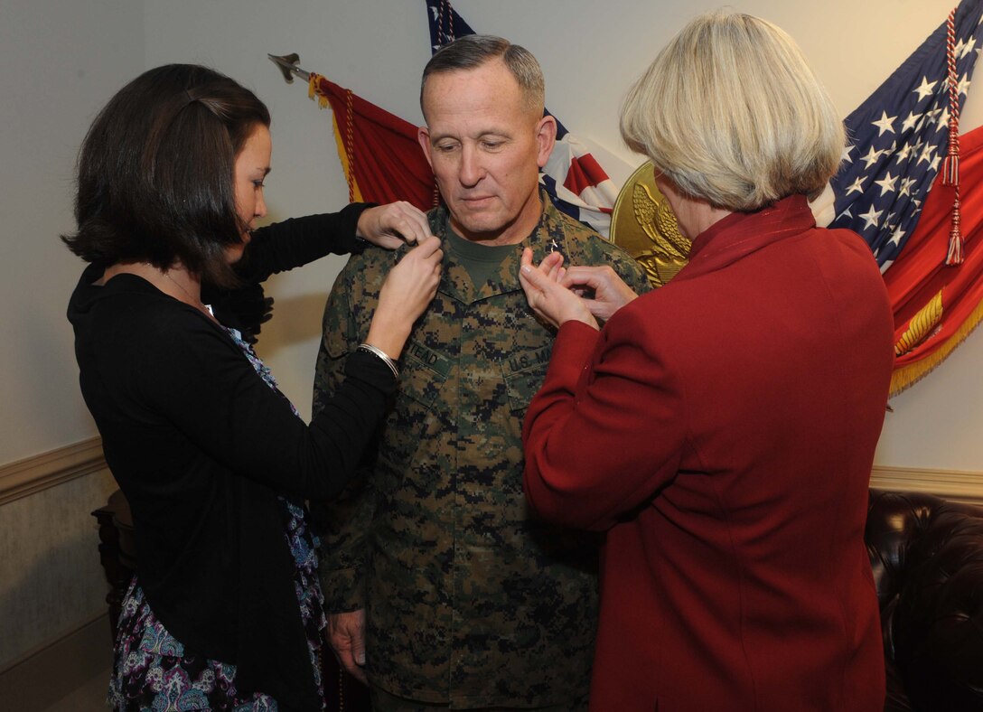 Lieutenant Gen. Robert E. Milstead Jr. has his new rank put on his collar by his daughter Melissa Milstead (left) and his wife Suzanne Milstead (right) Dec. 30 at the commandant of the Marine Corps’ office. He moved from his billet as the commanding general of Marine Corps Recruiting Command to take over as the deputy commandant for Manpower and Reserve Affairs on Jan. 3. The legacy left behind by Lt. Gen. Milstead will continue to impact the future direction of recruiting for the Marine Corps. (U.S. Marine Corps photo by Lance Cpl. James B. Purschwitz)