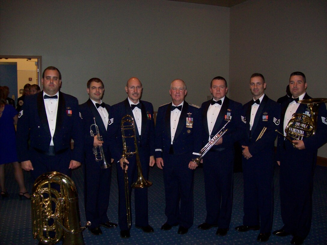 Members of the Brass in Blue performed at the AFSOC Order of the Sword ceremony at the Emerald Coast Conference Center in Fort Walton Beach, Fla., Nov. 19, 2010.  Brass in Blue is photographed with award recipient Lt. Gen. Donald Wurster, Air Force Special Operations Command commander.  Pictured, from left to right are: SSgt Matthew Holmberg, MSgt Jeffrey Pautz, SSgt Clay Sattazahn, Lt. Gen. Donald Wurster, TSgt Brian Stike, SSgt Edward Vaughen, TSgt Jeremy Buss.