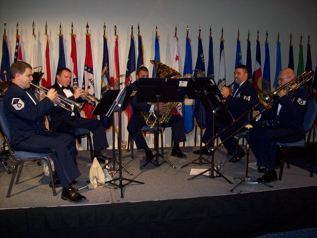MSgt Jeffrey Pautz, TSgt Brian Stike, SSgt Matthew Holmberg, TSgt Jeremy Buss and SSgt Clay Sattazahn, NCOIC, perform with the Brass in Blue at the AFSOC Order of the Sword ceremony at the Emerald Coast Conference Center in Fort Walton Beach, Fla., Nov. 19, 2010.