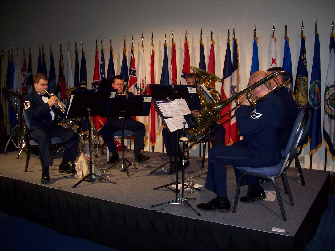 MSgt Jeffrey Pautz, TSgt Biran Stike, SSgt Matthew Holmberg, TSgt Jeremy Buss, and SSgt Clay Sattazahn, NCOIC, perform with the Brass in Blue at the AFSOC Order of the Sword ceremony at the Emerald Coast Conference Center in Fort Walton Beach, Fla., Nov. 19, 2010.