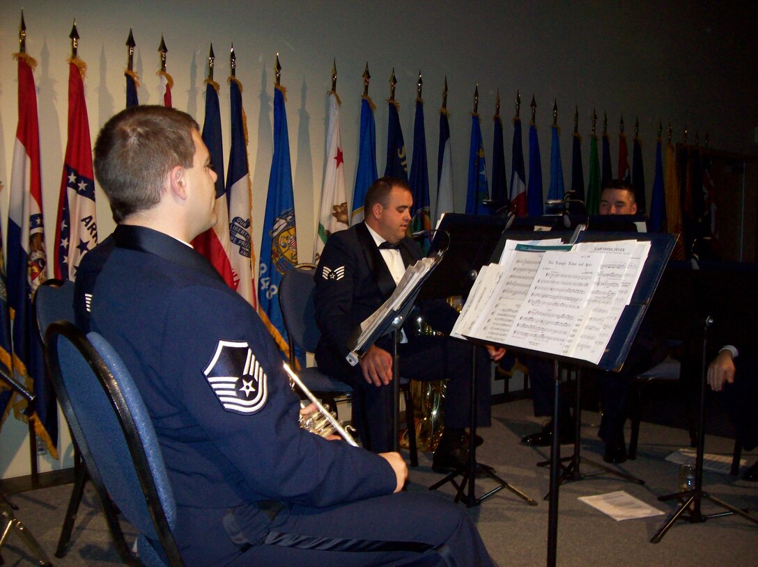 MSgt Jeffrey Pautz, SSgt Matthew Holmberg, and TSgt Jeremy Buss perform with the Brass in Blue at the AFSOC Order of the Sword ceremony at the Emerald Coast Conference Center in Fort Walton Beach, Fla., Nov. 19, 2010.