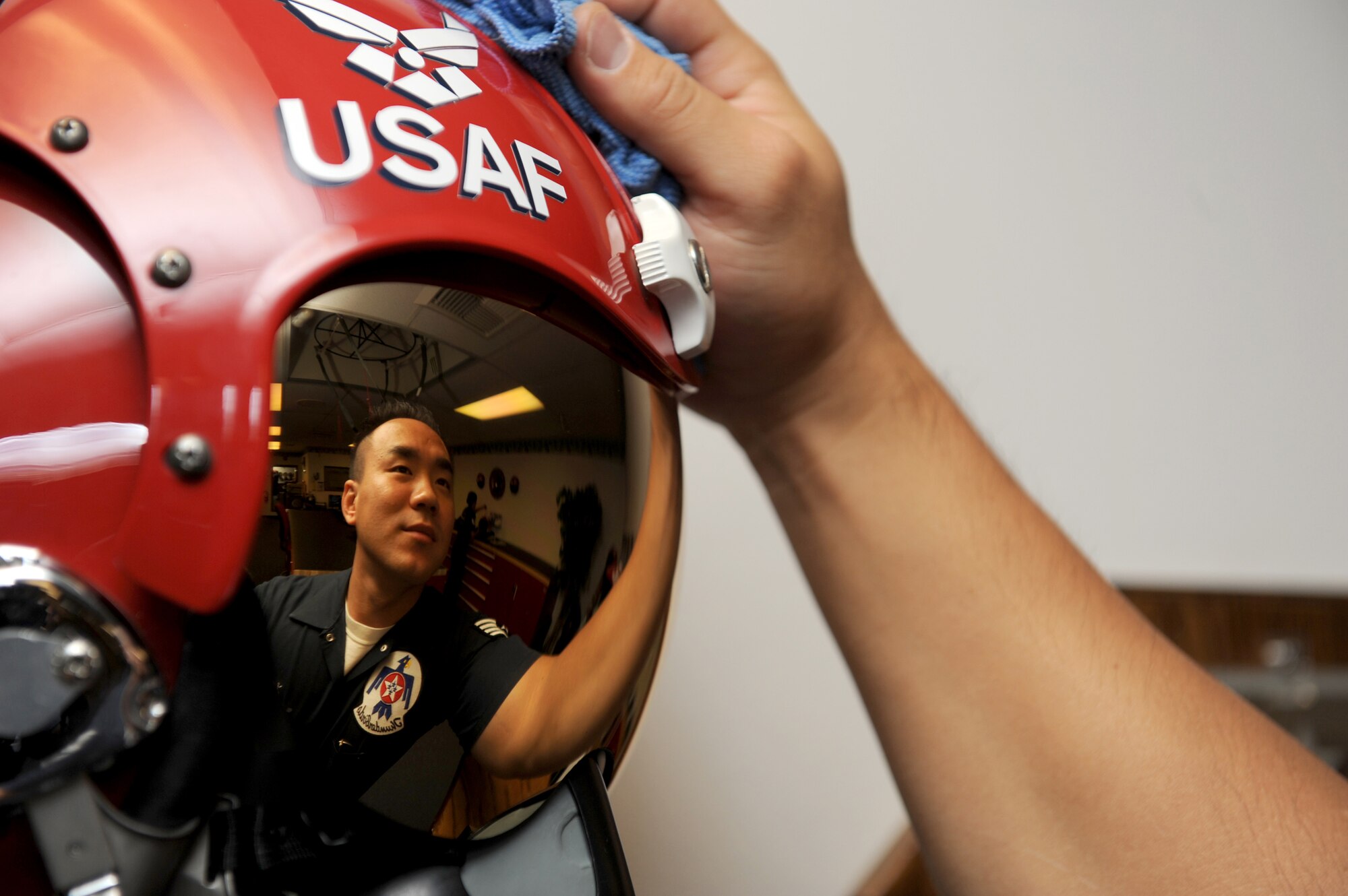 Staff Sgt. Sang Lee wipes down a display helmet in the U.S. Air Force Air Demonstration Squadron 'Thunderbirds' flight equipment room at Nellis Air Force Base, Nev., Dec. 17, 2010.  Sergeant Lee is an aircrew flight equipment specialist with the Thunderbirds.  (U.S. Air Force photo/Staff Sgt. Larry E. Reid Jr.)
