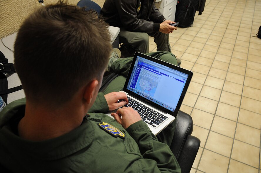 Nellis Air Force Base, Nev. -- When Uncle Sam is grounded due to bad weather conditions, the first thing to do is investigate when conditions will improve enough to fly again.  Here, Maj. Trey Hall, a pilot with the 927th Air Refueling Wing, examines current weather over the west coast to see if a landing will be feasible.  Knowing what the current weather conditions are before takeoff is the first step in planning a safe landing. (Official  U.S. Air Force photo by Staff. Sgt. Shawn C. Rhodes)