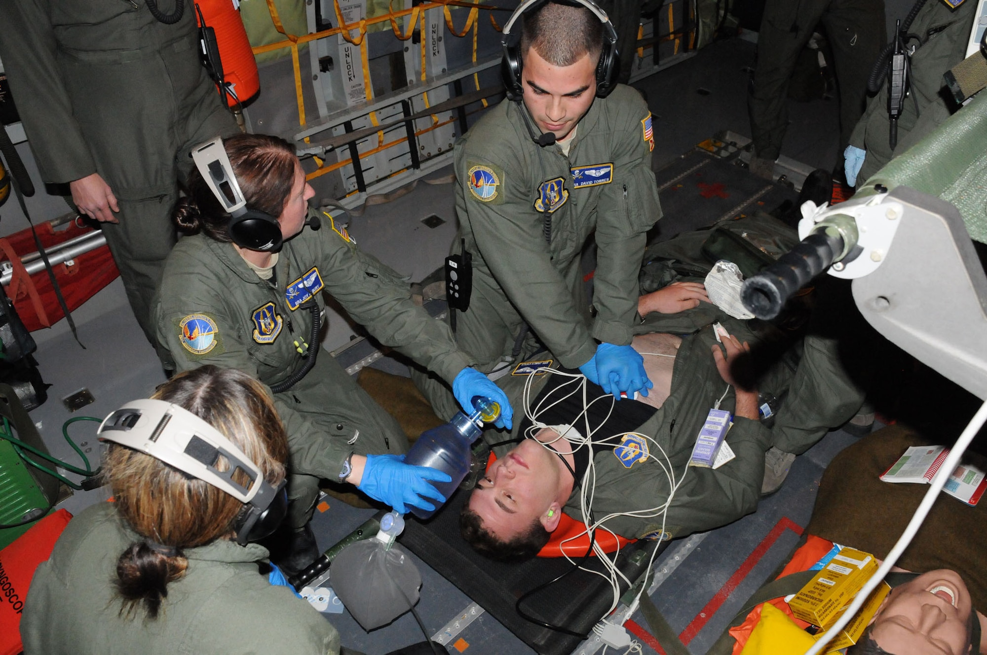 MacDill Air Force Base, Fla. -- For the airmen of the 63rd Aeromedical Evacuation Squadron, their jobs make the difference between life and death.  Their mission is to transport wounded troops from combat airfields to advanced care at modern hospitals.  In order to provide their patients with the best care possible, they regularly train on board aircraft.  Here, they are simulating care for a patient's cardiac arrest. (Official U.S. Air Force photo by Staff Sgt. Shawn Rhodes)