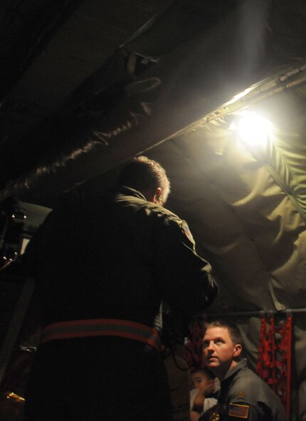 Hickam Air Force Base, Hawaii -- After an in-flight emergency was declared, servicemembers aboard the KC-135 worked to make sure the civilian passengers were taken care of.  Here, Maj. Trey Hall, a pilot with the 927th Air Refueling Wing speaks with Master Sgt. John Mercer, a boom operator with the same unit about the safety of the civilians aboard.  The emergency was declared after the pilots noticed smoke and fumes in the cockpit at 22,000 feet above the Pacific Ocean.  (Official U.S. Air Force photo by Staff Sgt. Shawn Rhodes)