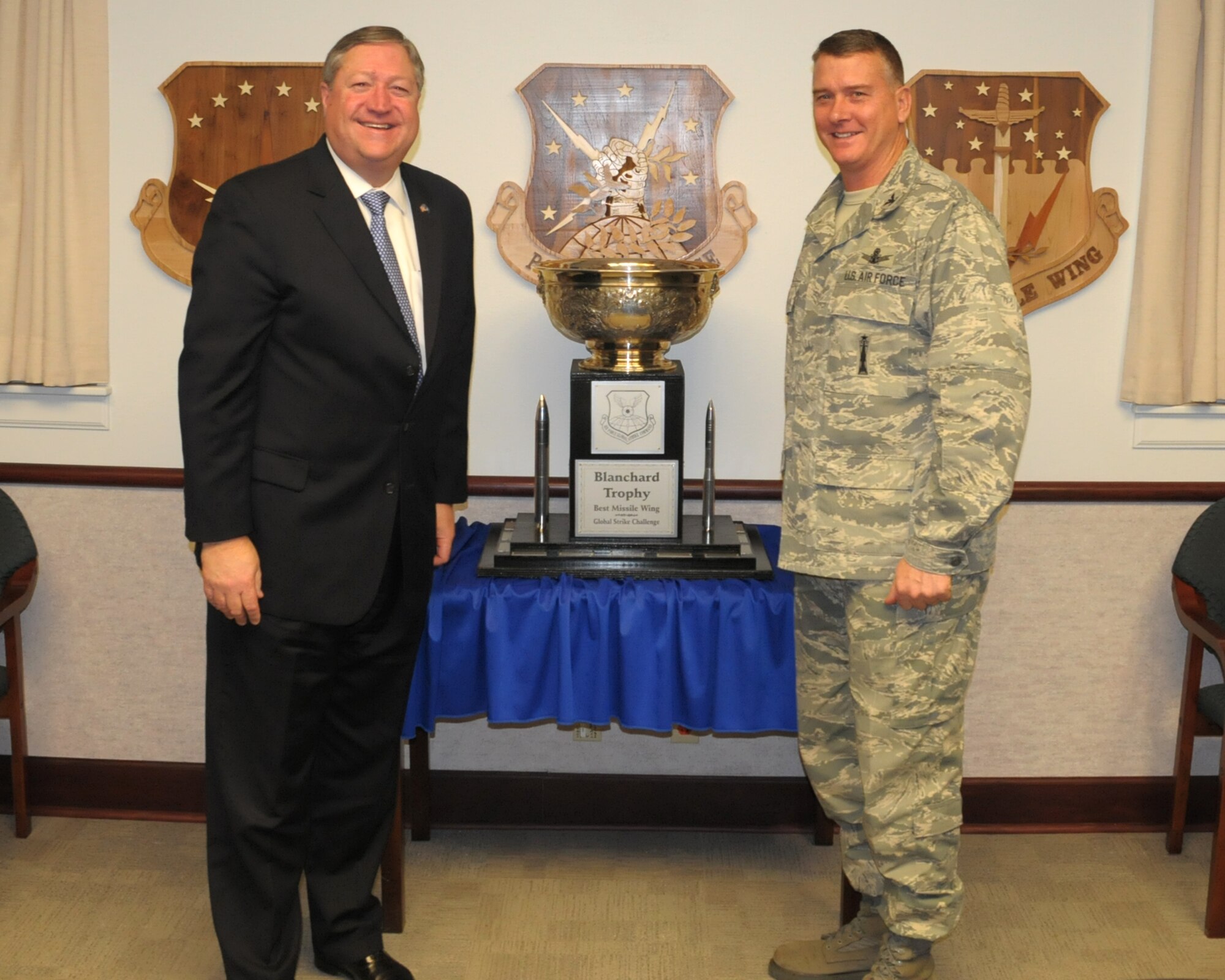 Secretary of the Air Force Michael Donley and Col. Greg Tims, 90th Missile Wing commander, pose next to the Blanchard Trophy during the secretary’s trip to F.E. Warren Air Force Base, Wyo., Dec. 23, 2010.  The 90th Missile Wing was awarded the trophy during Air Force Global Strike Command’s 2010 Global Strike Challenge competition in November, recognizing the unit as the Air Force’s best ICBM wing.  Secretary Donley said the great performance of the 90th Missile Wing during the Global Strike Challenge was reflective of Warren’s training, precision, dedication and professionalism.  (U.S. Air Force photo/Blaze Lipowski)