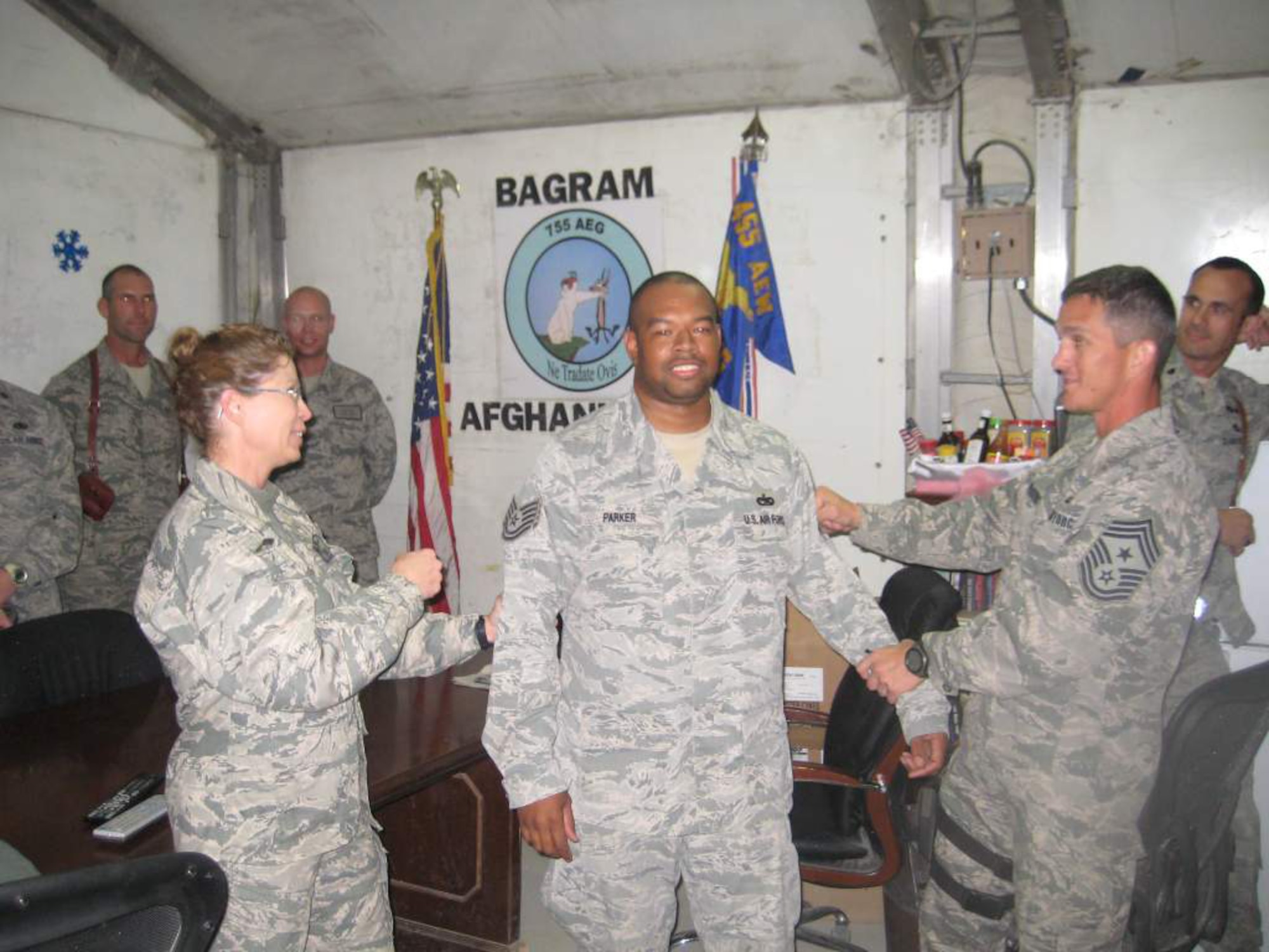 Tech. Sgt. George Parker, 627th Aerial Port Squadron, is STEP promoted at his deployed location a few days before Christmas. There are generally only two or three STEP allocations given to each Wing per year. Wing commanders can then use these allocations to promote outstanding individuals to Staff Sergeant, Technical Sergeant, and Master Sergeant. (U.S. Air Force courtesy photo)