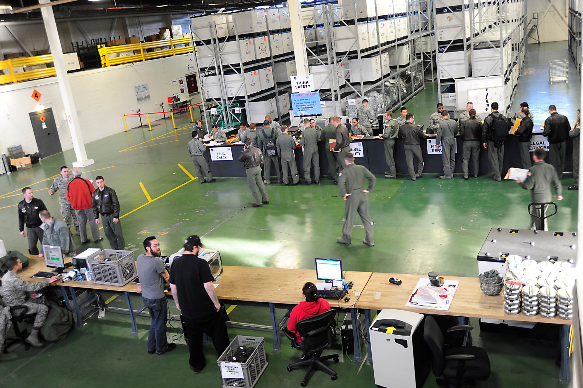 Airmen assigned to the 7th Airlift Squadron pass through the deployment processing line in preparation for deployment Dec. 23 at McChord Field, Joint Base Lewis-McChord, Wash. The Airmen deployed to an overseas location in support of Operations Enduring Freedom, New Dawn and CJTF Horn of Africa. (U.S. Air Force photo/Adamarie Lewis-Page)