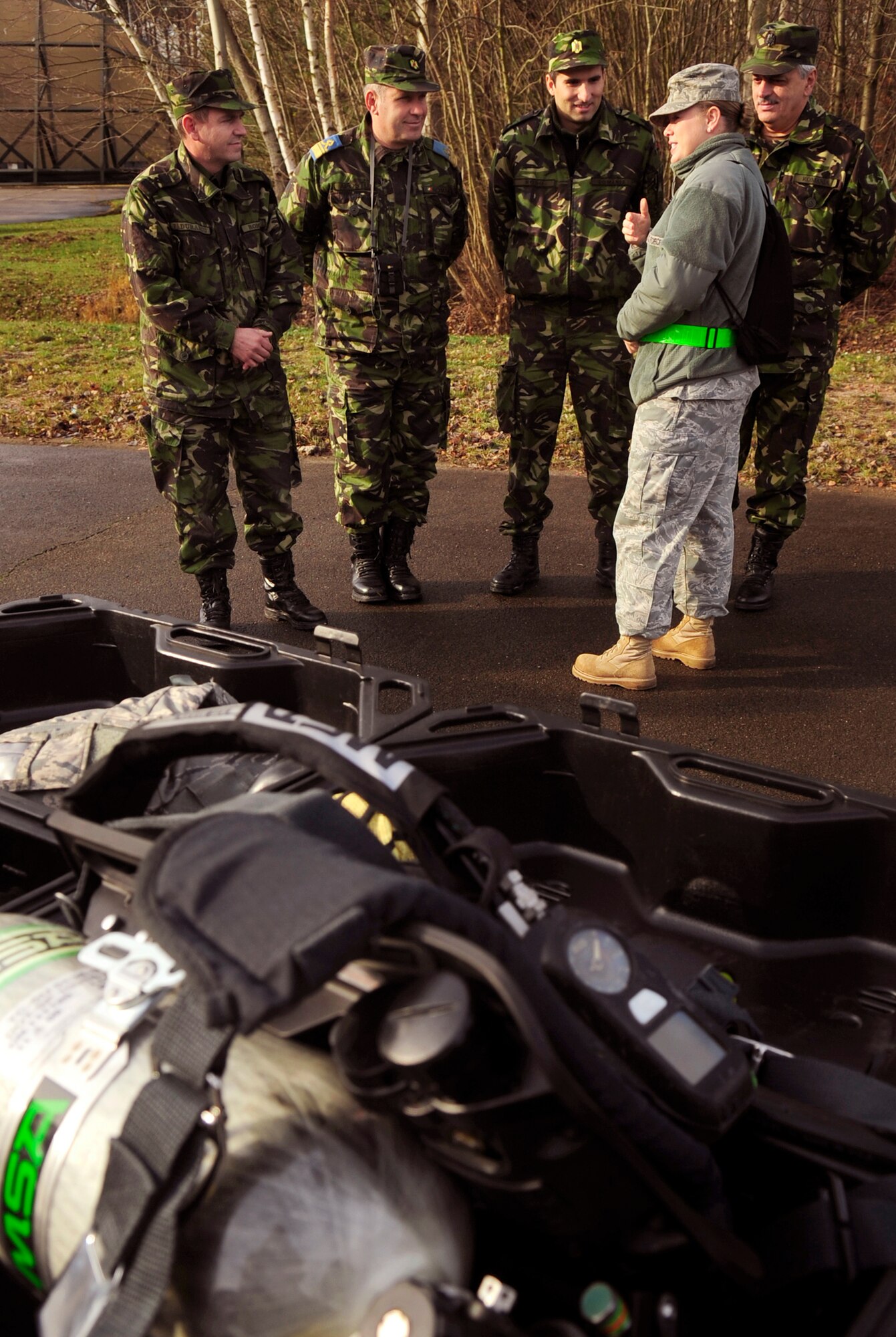 Staff Sgt. Rebecca Tongen briefs members of the Romanian air force on the particulars of the chemical, biological, radiological, nuclear and high yield explosive training station, Nov. 20, 2010, during the practical exercise of Silver Flag at Ramstein Air Base, Germany. Silver flag is a weeklong, ongoing training program that combines classroom and practical application exercises to prepare Airmen for deployment scenarios. Members of the Romanian air force were invited to observe training and share information. Sergeant Tongen is a Silver Flag cadre member. (U.S. Air Force photo/Tech. Sgt. Jocelyn Rich)
