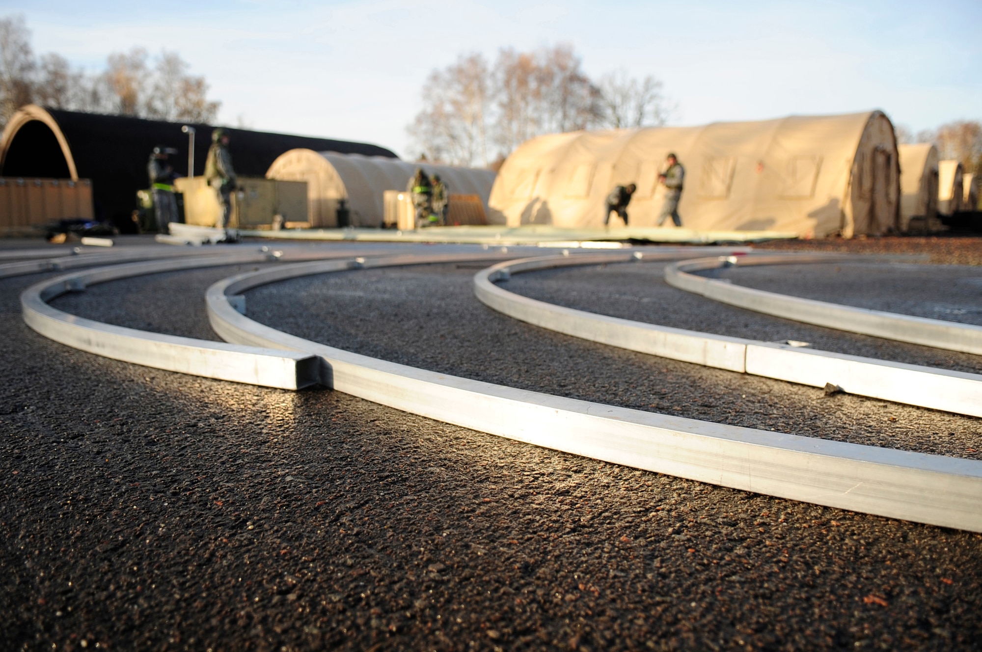 Airman lay supports for a tent in preparation of tent build-up during a practical application portion of Silver Flag Nov. 20, 2010, at Ramstein Air Base, Germany. Silver Flag is a weeklong, ongoing training program that invites Airmen from all over the planet to participate. Members of NATO forces have also been invited to attend. Silver Flag combines classroom and practical application exercises to prepare Airmen for deployment. (U.S. Air Force photo/ Tech. Sgt. Jocelyn Rich)
