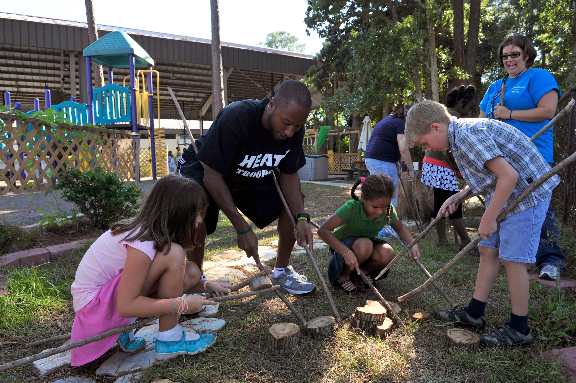 Kenny Hasbrouck works on a team building activity with children at the outdoor classroom at the youth center Sept. 30, 2010, at Hurlburt Field Fla. In November 2009 the classroom became the 29th Arbor Day Foundation and Dimensions Educational Research Foundation-certified Nature Explore classroom in the country. Mr. Hasbouck is player for the NBA's Miami HEAT. (U.S. Air Force photo/Staff Sgt. Stephanie Jacobs)
