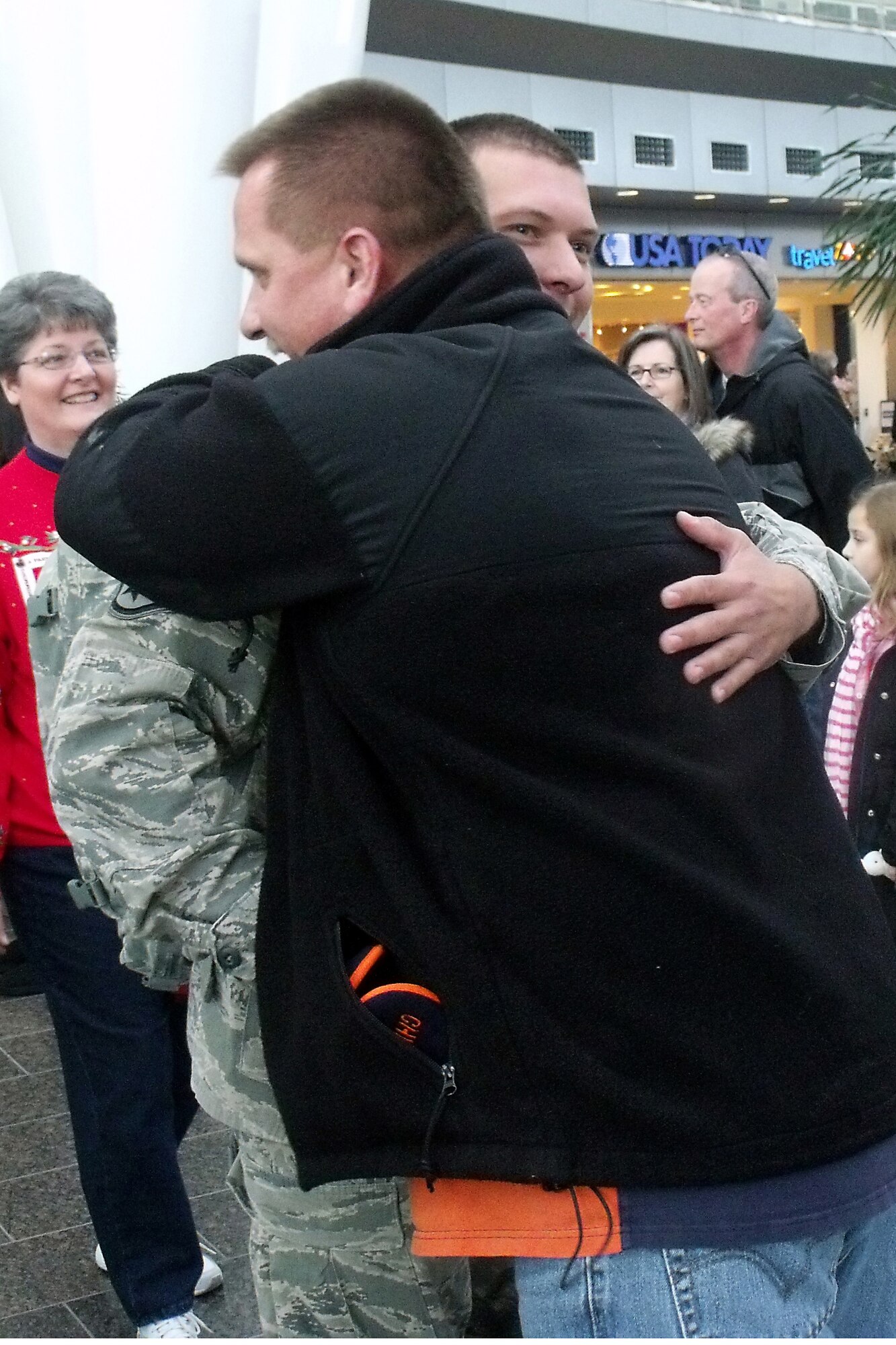 GRISSOM AIR RESERVE BASE, Ind.--  Retired Chief Master Sgt. David Sajdyk hugs Staff Sgt. Ryan Ule as he welcomes him and four other 434th Civil Engineer Squadron firefighters back from a recent deployment to Southwest Asia Dec. 23. Sergeant Ule is a fire protection specialist and Chief Sajdyk recently retired from the unit as fire chief. (U.S. Air Force photo/Senior Airman Jamia Nalls)

