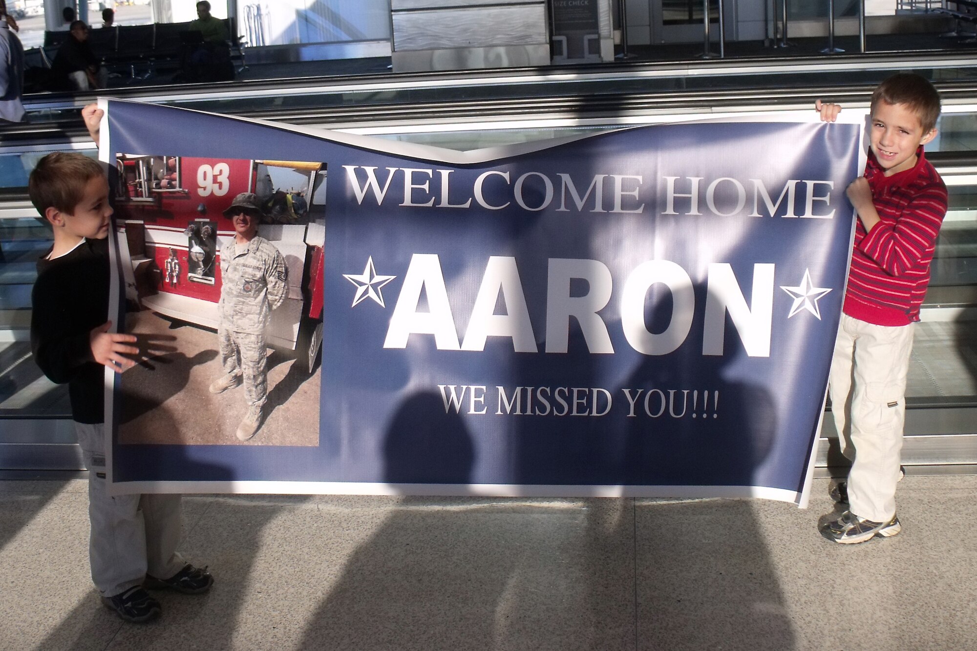 GRISSOM AIR RESERVE BASE, Ind. -- Family members of Tech. Sgt. Aaron Dehner, 434th Civil Engineer Squadron firefighter, hold a banner up as they wait for him at Indianapolis International Airport. Sergeant Dehner and four other 434th CES firefighters returned from a recent deployment to Southwest Asia Dec. 23. (U.S. Air Force photo/Senior Airman Jamia Nalls)
