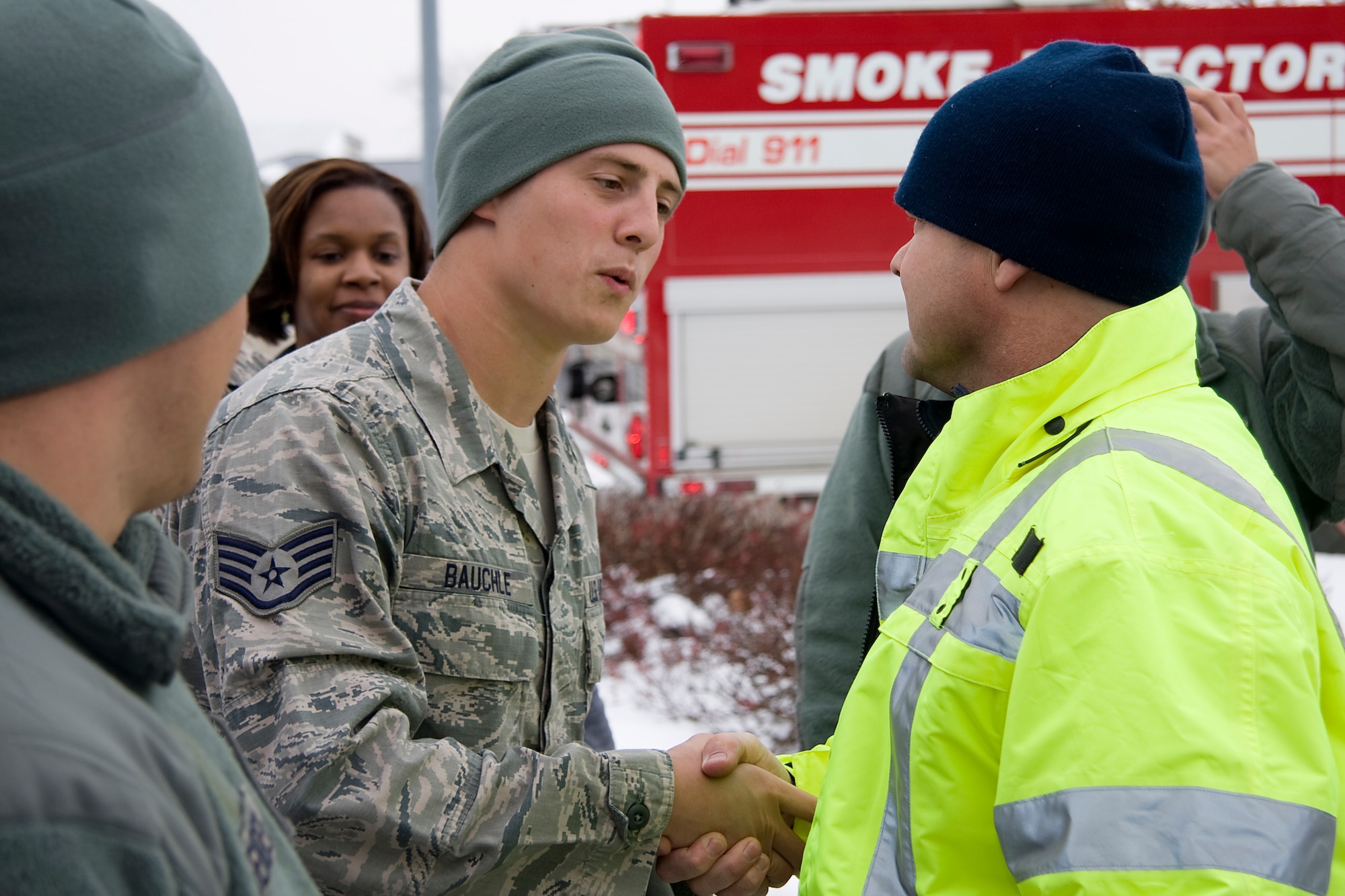 GRISSOM AIR RESERVE BASE, Ind. -- David Perryman shakes the hand of Staff Sgt. Christopher Bauchle as he welcomes him home from a deployment Dec. 23. Sergeant Bauchle, along with four other 434th Civil Engineer Squadron firefighters, recently returned just two days before Christmas from a four-month deployment to Southwest Asia. Mr. Perryman is a firefighter with the Grissom Fire Department. (U.S. Air Force photo/Tech. Sgt. Mark R. W. Orders-Woempner)
