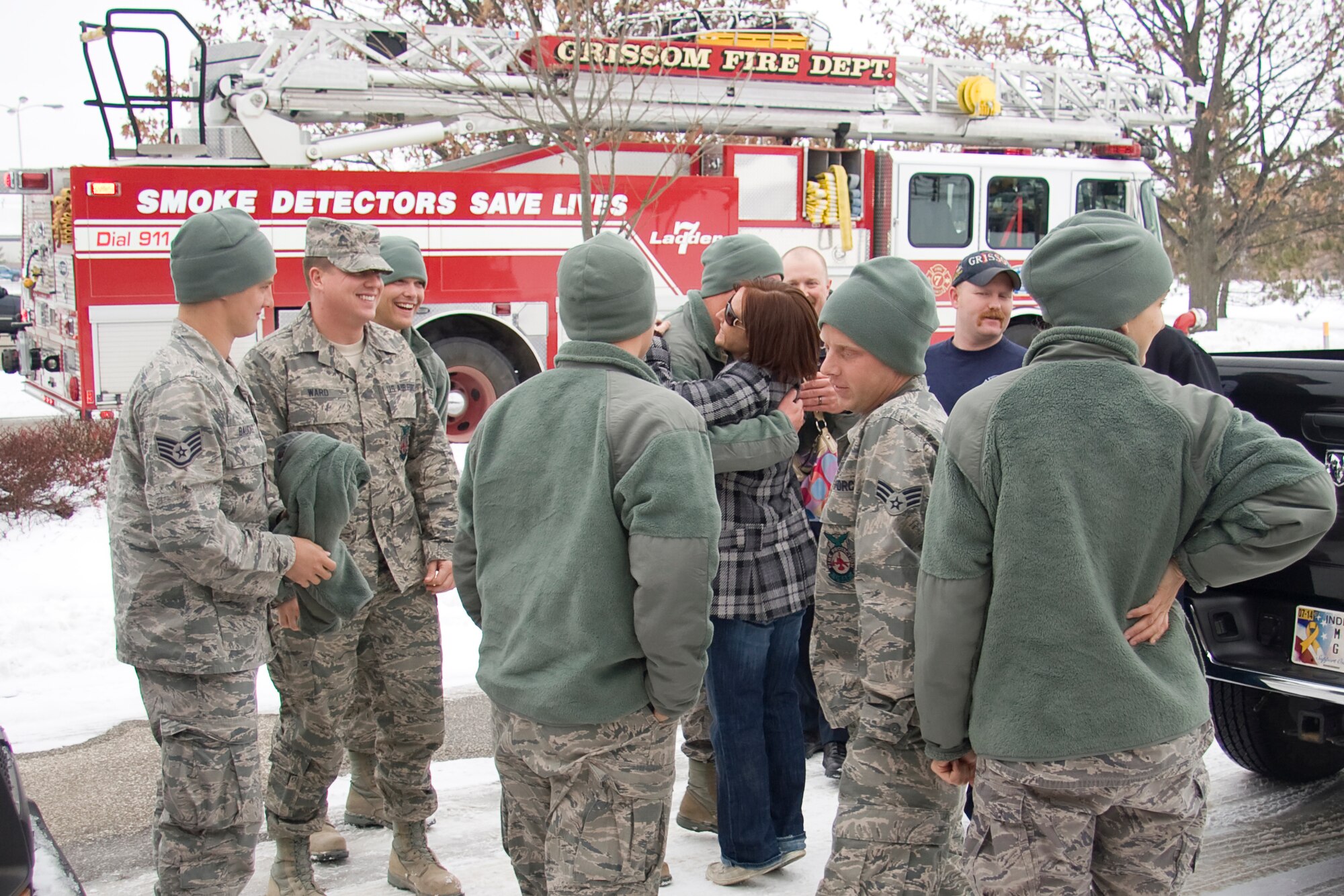 GRISSOM AIR RESERVE BASE, Ind. -- Rebekah Dehner hugs her husband, Tech. Sgt. Aaron Dehner, as she and Grissom?s civilian firefighters welcome back a group of 434th Civil Engineer Squadron firefighters from a recent deployment to Southwest Asia Dec. 23.  (U.S. Air Force photo/Tech. Sgt. Mark R. W. Orders-Woempner)
