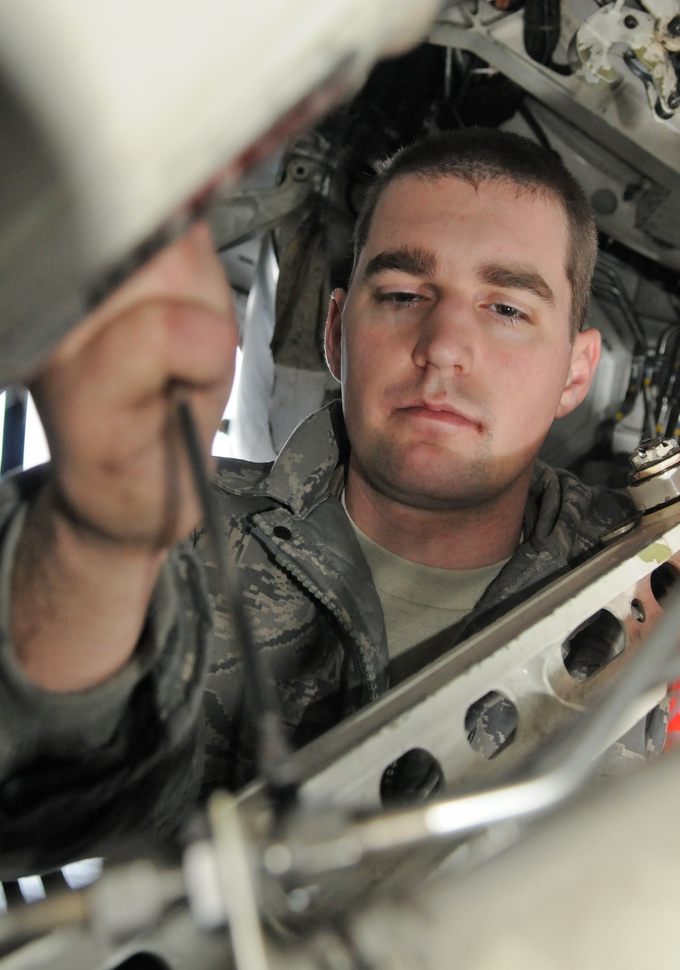 SPANGDAHLEM AIR BASE, Germany – Staff Sgt. Ryan Merrill, 480th Aircraft Maintenance Unit dedicated crew chief, uses a wrench to remove a nut on an F-16 Fighting Falcon during a “cannibalization bird” process Dec. 30. The can-bird process is a maintenance process in which one aircraft is taken apart to supply mission capable parts that will be used by remaining aircraft in the fleet. (U.S. Air Force photo/Senior Airman Nick Wilson)