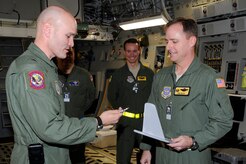 Air Force Brig. Gen. Carlton D. Everhart II hands the keys to Col. John Wood after delivering the newest C-17 Globemaster III to the 437th Airlift Wing, Charleston, S.C., Dec. 22, 2010. The arrival of the aircraft brings the total number of C-17s assigned to the wing to 59. General Everhart is the 618th Air and Space Operations vice commander and Colonel Wood is the 437th AW commander. (U.S. Air Force photo/Staff Sgt. Marie Brown)