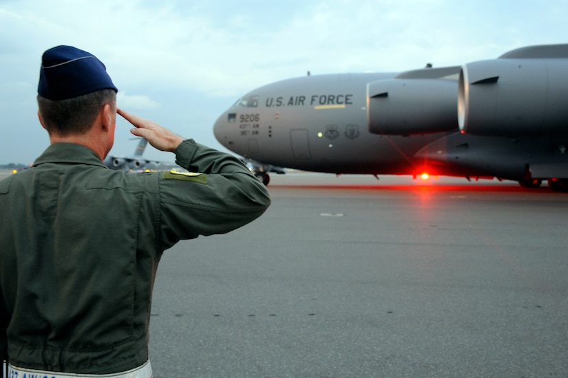 Air Force Col. John Wood salutes Brig. Gen. Carlton D. Everhart II as he taxis the newest C-17 Globemaster III aircraft on the Joint Base Charleston, S.C., flightline Dec. 22, 2010. The arrival of the aircraft brings the total number of C-17s assigned to the 437th Airlift Wing to 59. General Everhart is the 618th Air and Space Operations vice commander and Colonel Wood is the 437th AW commander. (U.S. Air Force photo/Staff Sgt. Marie Brown)