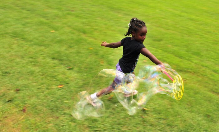 Addison Chavis races with her bubbles during the summer reading finale at the base picnic grounds Aug. 7, 2010, on Joint Base Charleston, S.C. At the bubble station, Addison and fellow summer readers tried to create the biggest bubbles and continued the fun with sidewalk chalk in sunny, florescent colors. Addison is the daughter of Allen and Robyn Chavis. Mr. Chavis is a civilian contractor with Scientific Research Corporation. 