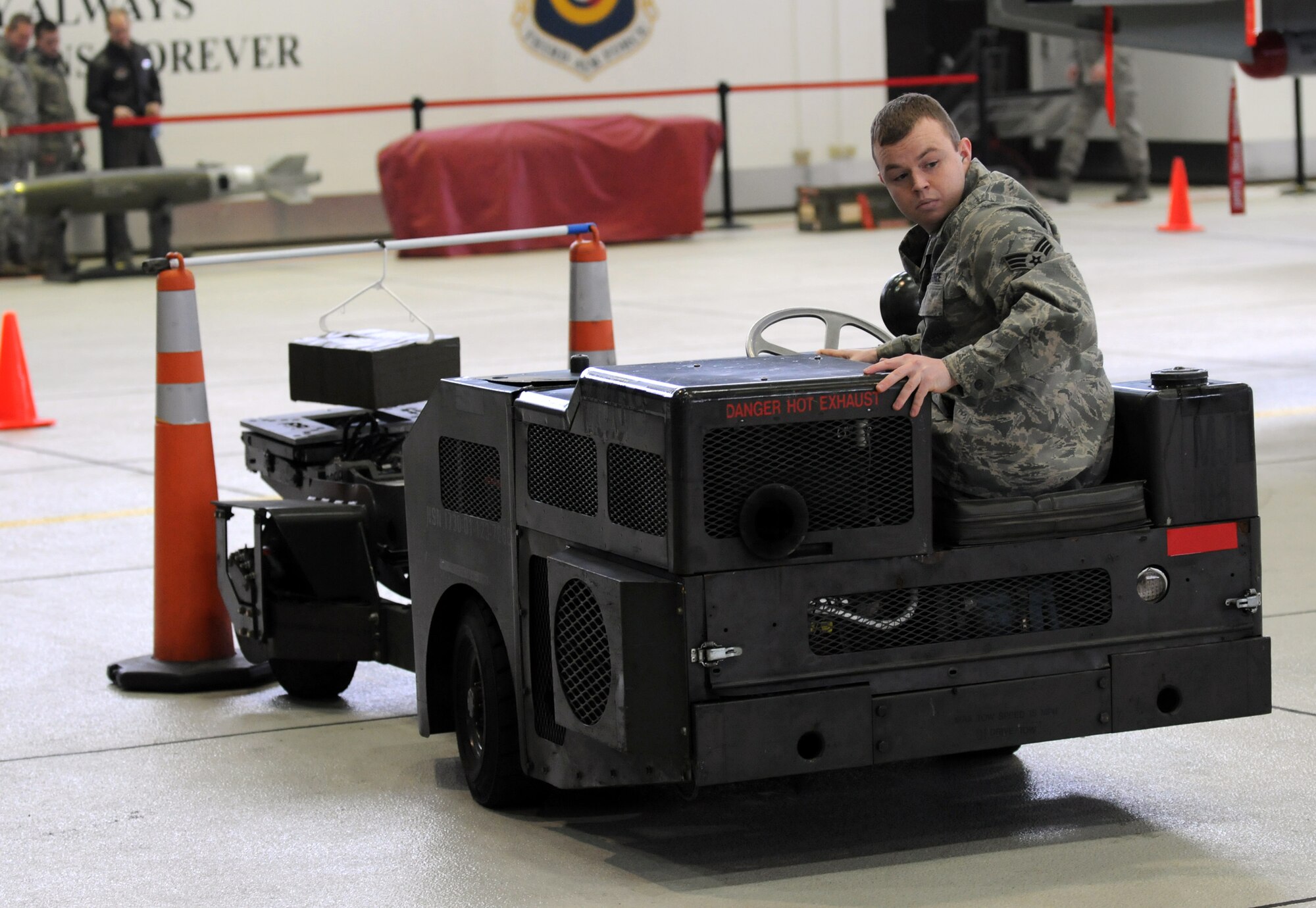 SPANGDAHLEM AIR BASE, Germany – Senior Airman Malcom Hart, 52nd Aircraft Maintenance Unit weapons load crew member, backs away after hanging a package on a pole while driving an MJ-1 during the Jammer Driver of the Year competition Dec. 28. Winners of the Jammer Driver of the Quarter competitions from the 2010 year competed in the event for the title of Jammer Driver of the Year. The winners of the Load Crew of the Year, and the Jammer Driver of the Year, will be announced during the Annual Awards Ceremony. (U.S. Air Force photo/Airman 1st Class Matthew B. Fredericks)