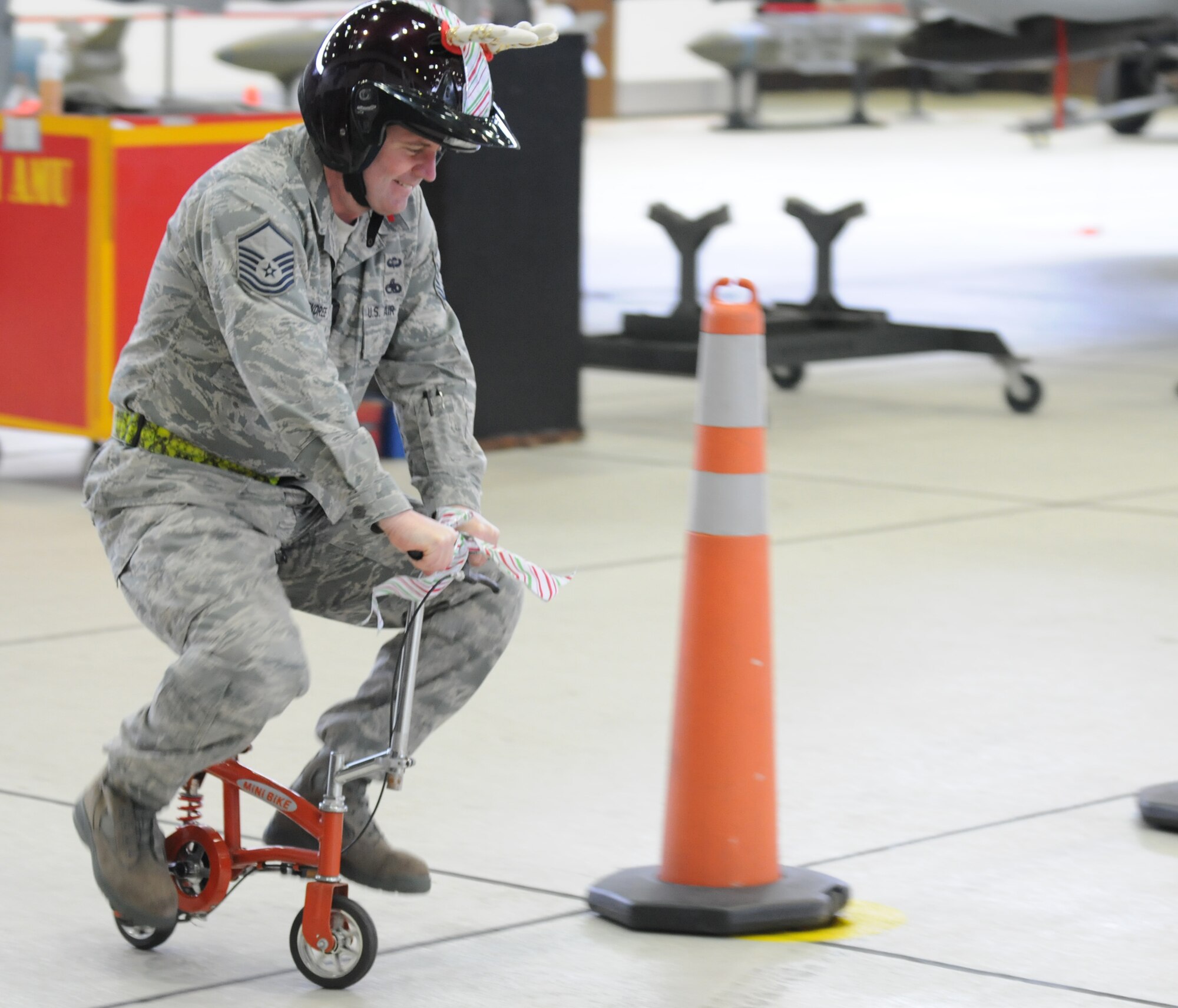 SPANGDAHLEM AIR BASE, Germany – Master Sgt. Chambliss McKendree, 52nd Aircraft Maintenance Squadron weapons flight chief, navigates a course of road cones on a small bicycle during an intermission between the Load Crew of the Year and Jammer Driver of the Year competitions. Sergeant McKendree competed against fellow Weapons Flight Chiefs to see who could navigate the course in the fastest time. The winners of the Load Crew of the Year, and the Jammer Driver of the Year, will be announced during the Annual Awards Ceremony. (U.S. Air Force photo/Airman 1st Class Matthew B. Fredericks)