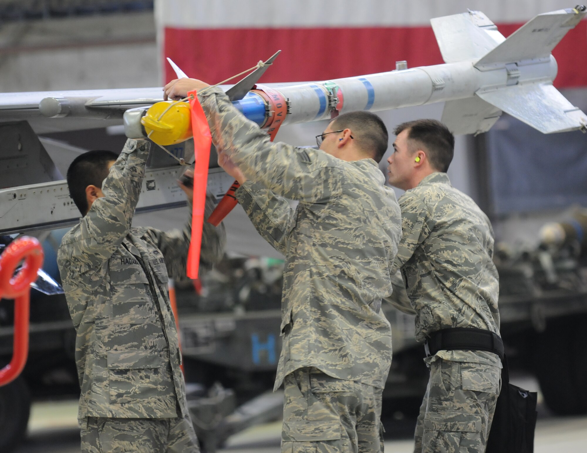 SPANGDAHLEM AIR BASE, Germany – Members of an 480th Aircraft Maintenance Unit weapons load crew work together during the Load Crew of the Year competition held in Hanger 1 Dec. 28. The winners of the Load Crew of the Quarter competitions of 2010 competed against each other for the fastest time to load munitions onto their aircraft. The winners of the Load Crew of the Year, and the Jammer Driver of the Year, will be announced during the Annual Awards Ceremony. (U.S. Air Force photo/Airman 1st Class Matthew B. Fredericks)