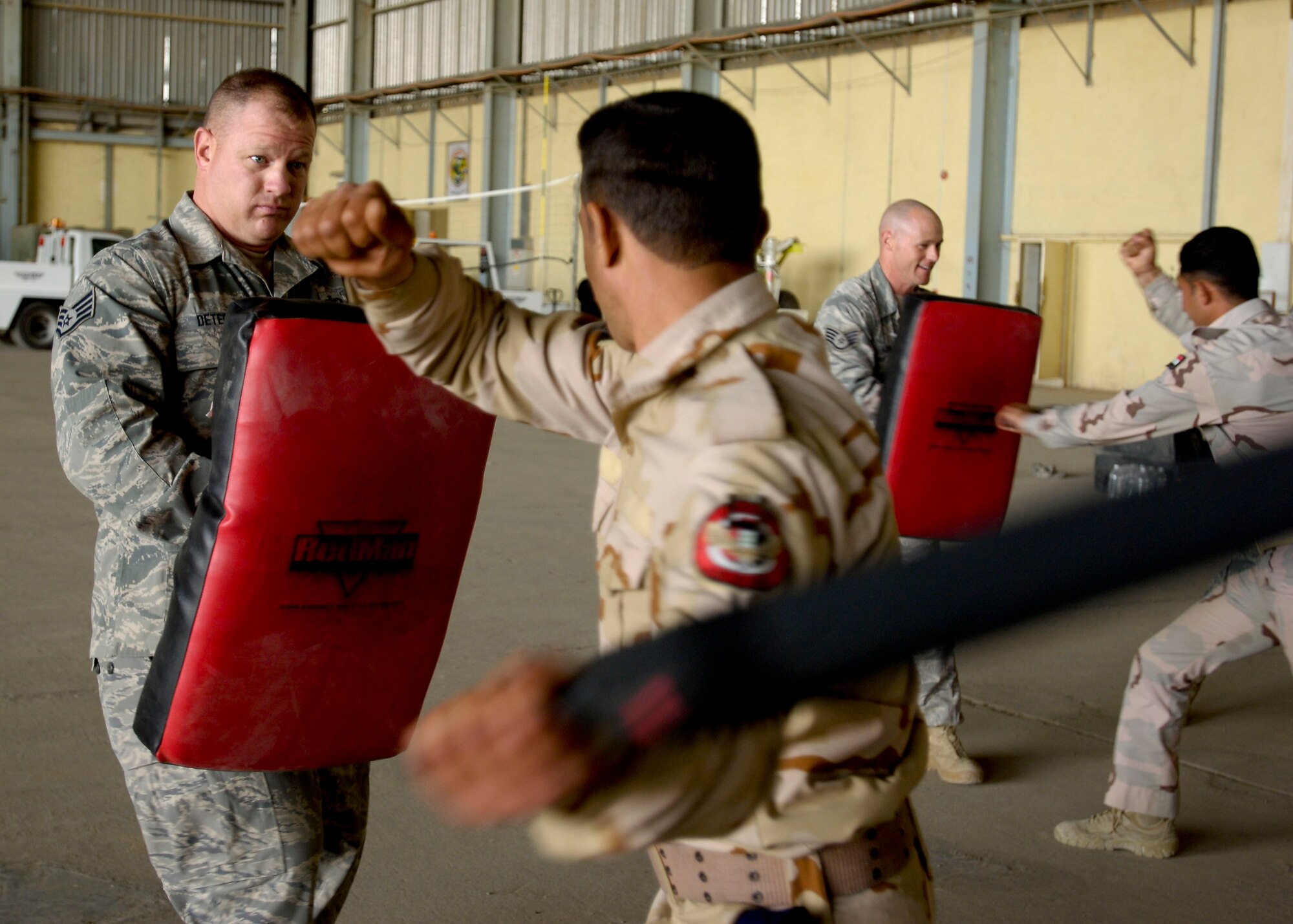 Staff Sgt. Timothy DeTerra, New Al-Muthana Air Base Transition Team member, defends himself from a baton attack by a member of the Iraqi Air Force during a training session Dec. 23.  This training is the first of its kind held at NAMAB, and promises to help the IqAF build a reliable and secure force in the year ahead.  (U.S. Air Force photo by Tech. Sgt. Randy Redman, Released)