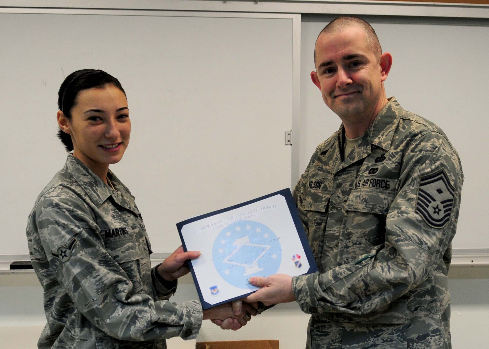 Airman Jessica Martins, 39th Security Forces Squadron, is presented the 'Diamond Sharp' award by Senior Master Sgt. Phillip Wilson, 39th SFS first sergeant, on behalf of the Incirlik First Sergeant’s Council Dec. 29, 2010 at Incirlik Air Base, Turkey.  Airman Martins earned the monthly award for December by distinguishing herself through outstanding professionalism, performance and display of the Air Force core values. (U.S. Air Force photo by Senior Airman Ashley Wood/Released) 