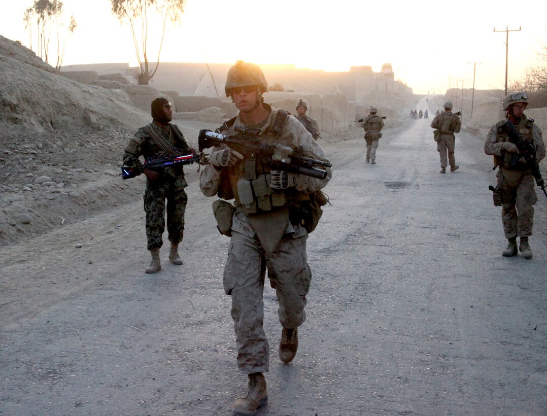 Cpl. Jason Albright, a team leader with 3rd Platoon, India Company, 3rd Battalion, 5th Marine Regiment, leads Coalition forces down route 611, back to Patrol Base Fulod, in Sangin District, Dec. 30. The 21-year-old native of Chicago Ridge, Ill., has been deployed to Helmand province, in support of Operation Enduring Freedom since October.