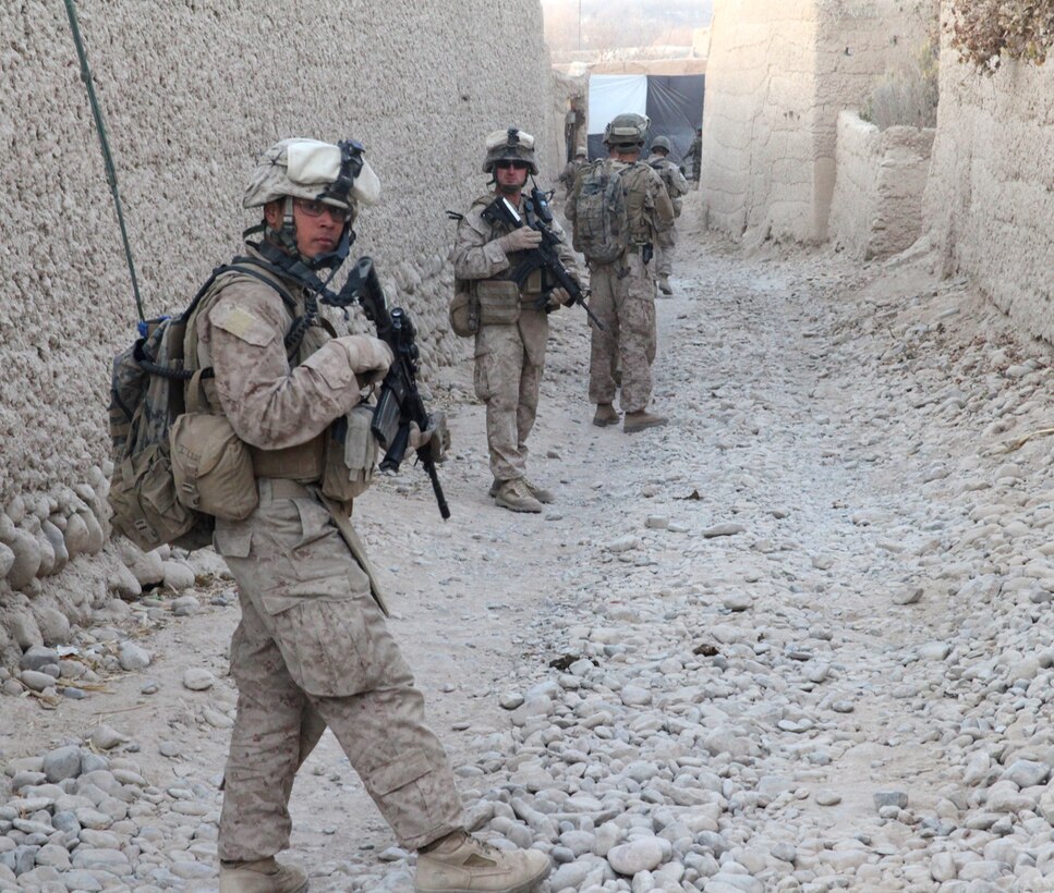 Lance Cpl. Ron Long, Jr., a radio operator with 3rd Plt., India Company, 3rd Battalion, 5th Marine Regiment, searches for any suspicious activity during a patrol in the Sangin District, Dec. 30. The 21-year-old native of Galt, Calif., has been deployed to Helmand province, in support of Operation Enduring Freedom since October.