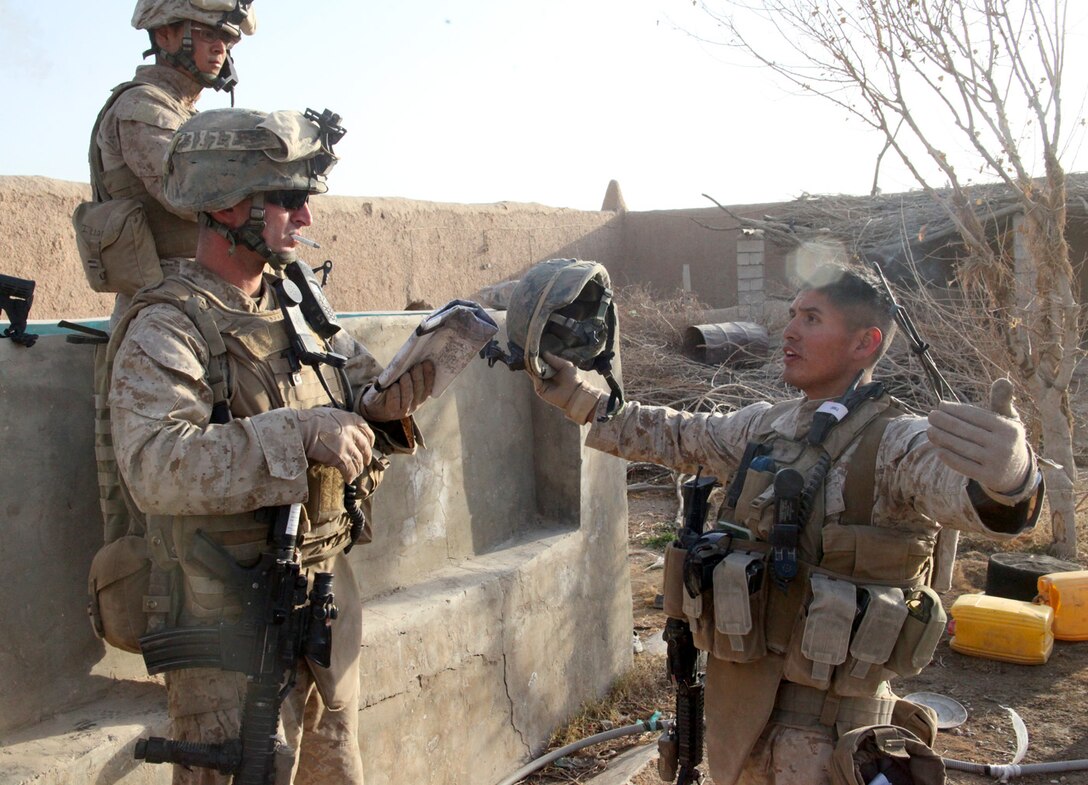 U.S. Marine Corps 1st Lt. Josef Patterson, 3rd Platoon, platoon commander, and Sgt. David “Bibi” Castillo, 2nd Squad, squad leader, both with India Company, 3rd Battalion, 5th Marine Regiment, discuss plans to advance their squad through a danger area during a patrol in Sangin District, Dec. 30. Danger areas are open spaces where no cover or concealment is available and the Marines are vulnerable to enemy fire.