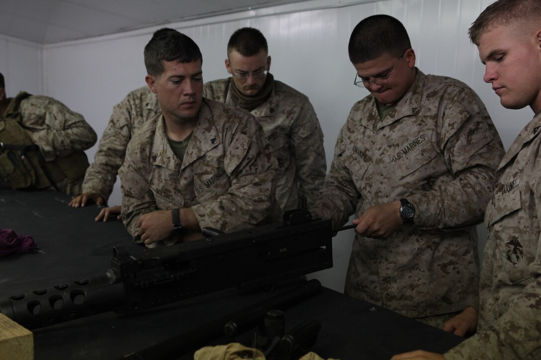 101231-M-8875C-022 CAMP BUEHRING, Kuwait (Dec. 31, 2010) -- Lance Cpl. Juan Umanzar, a heavy equipment mechanic with Combat Logistics Battalion 26, 26th Marine Expeditionary Unit, rehearses disassembly of an M2 .50 caliber machine gun during a disassembly and assembly class held prior to a convoy live-fire exercise at a training area near Camp Buehring, Kuwait, Dec. 31, 2010. Elements of 26th MEU debarked the ships of Kearsarge Amphibious Ready Group to conduct sustainment training and exercises with regional allies and partners in the U.S. 5th Fleet's area of responsibility. (Official USMC photo by Lance Cpl. Santiago G. Colon Jr./Released)::r::::n::