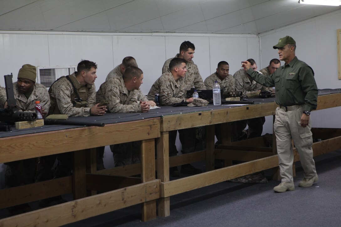 101231-M-8875C-052 CAMP BUEHRING, Kuwait (Dec. 31, 2010) -- David J. Quintanilla, right, a Military Professional Resources Incorporated instructor, speaks to Marines with Combat Logistics Battalion 26, 26th Marine Expeditionary Unit, during an M2 .50 caliber machine gun disassembly and assembly class held prior to a convoy live-fire exercise at a training area near Camp Buehring, Kuwait, Dec. 31, 2010. Elements of 26th MEU debarked the ships of Kearsarge Amphibious Ready Group to conduct sustainment training and exercises with regional allies and partners in the U.S. 5th Fleet's area of responsibility. (Official USMC photo by Lance Cpl. Santiago G. Colon Jr./Released)::r::::n::