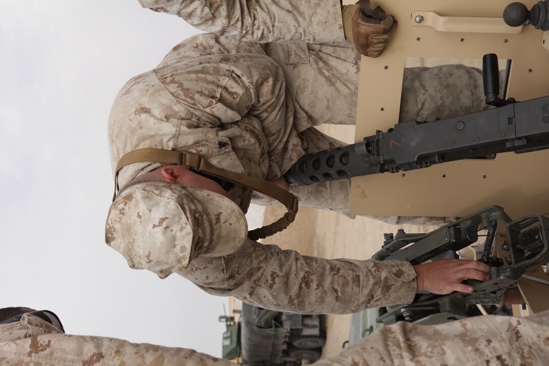 101231-M-8875C-188 CAMP BUEHRING, Kuwait (Dec. 31, 2010) – Cpl. Justin Lindsey, a combat engineer with Combat Logistics Battalion 26, 26th Marine Expeditionary Unit, places an M2 .50 caliber machine gun onto the turret of a Mine Resistant and Armor Protected Military All-Terrain Vehicles for a convoy live-fire exercise at a training area near Camp Buehring, Kuwait, Dec. 31, 2010. Elements of 26th MEU debarked the ships of Kearsarge Amphibious Ready Group to conduct sustainment training and exercises with regional allies and partners in the U.S. 5th Fleet's area of responsibility. (Official USMC photo by Lance Cpl. Santiago G. Colon Jr./Released) ::r::::n::::r::::n::