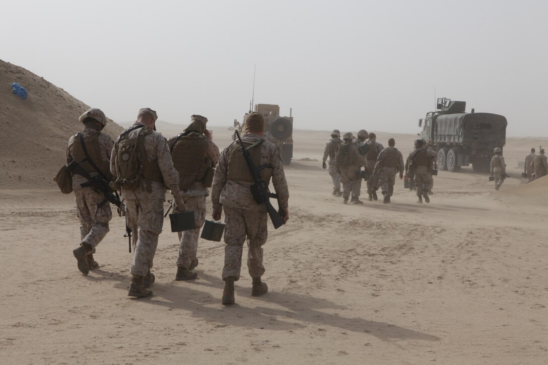 101231-M-8875C-263 CAMP BUEHRING, Kuwait (Dec. 31, 2010) -- Marines with Combat Logistics Battalion 26, 26th Marine Expeditionary Unit, walk to the firing line with their rounds prior to a convoy live-fire exercise at a training area near Camp Buehring, Kuwait, Dec. 31, 2010. Elements of 26th MEU debarked the ships of Kearsarge Amphibious Ready Group to conduct sustainment training and exercises with regional allies and partners in the U.S. 5th Fleet's area of responsibility. (Official USMC photo by Lance Cpl. Santiago G. Colon Jr./Released) ::r::::n::