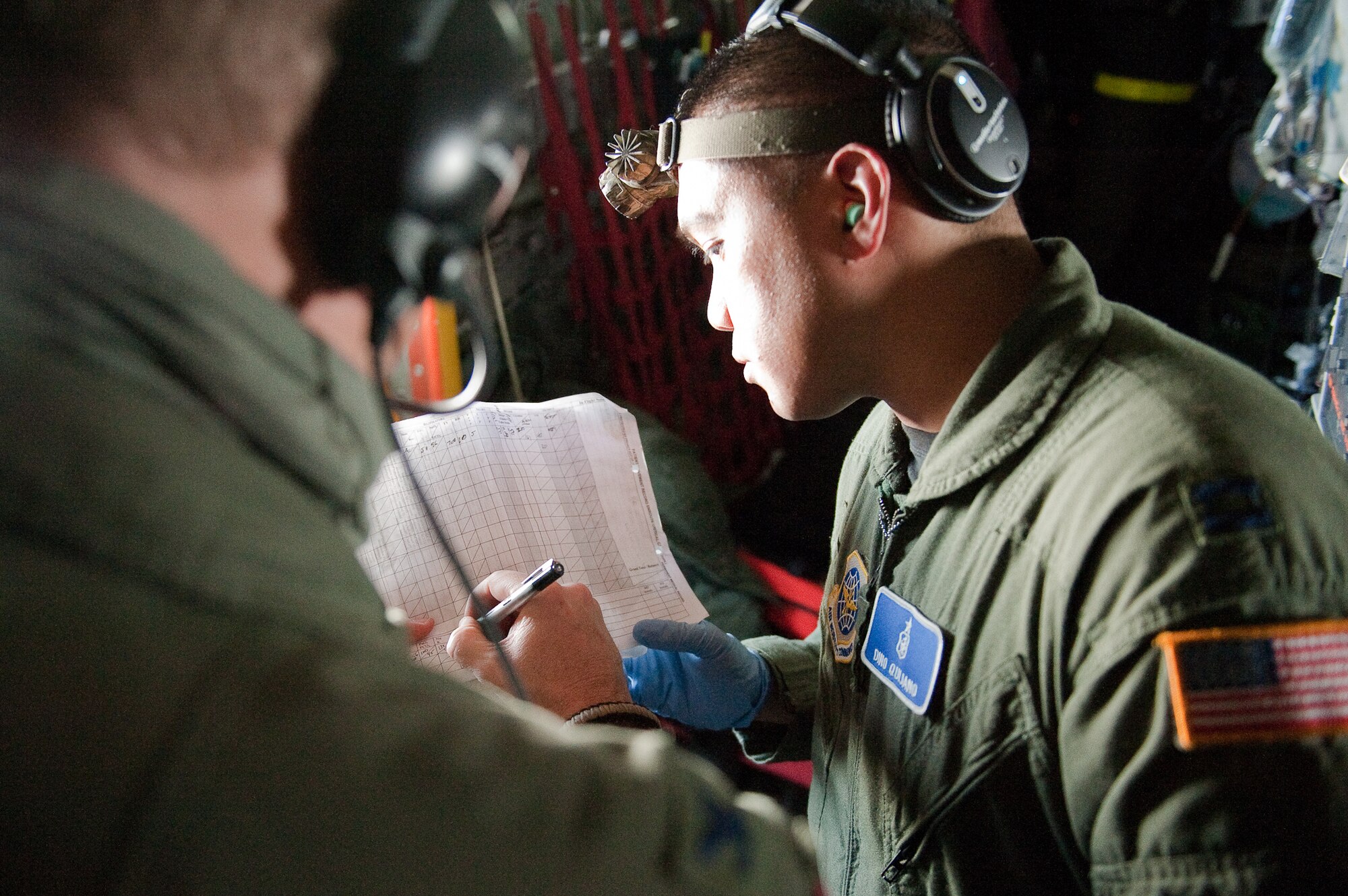 CINCINNATI, OHIO -- Col. Todd Carter (left), an Air Force medical instructor, helps Capt. Dino Quijano annotate patient records during an aeromedical training exercise over the skies of southern Ohio on Feb. 11, 2010. Captain Quijano, a nurse from the 60th Inpatient Squadron at Travis Air Force Base, Calif., was participating in a two-week Critical Care Air Transport Team course designed to provide medical personnel with total immersion in the care of severely injured patients. Ground training and simulated-flight training are conducted at the University of Cincinnati, one of four Air Force Centers for Sustainment of Trauma and Readiness Skills (CSTARS) nationwide, but the final day of instruction is provided while airborne in a Kentucky Air Guard C-130. Kentucky's 165th Airlift Squadron began providing C-130s to use as a CSTARS training platform in 2009. (U.S. Air Force by Maj. Dale Greer)