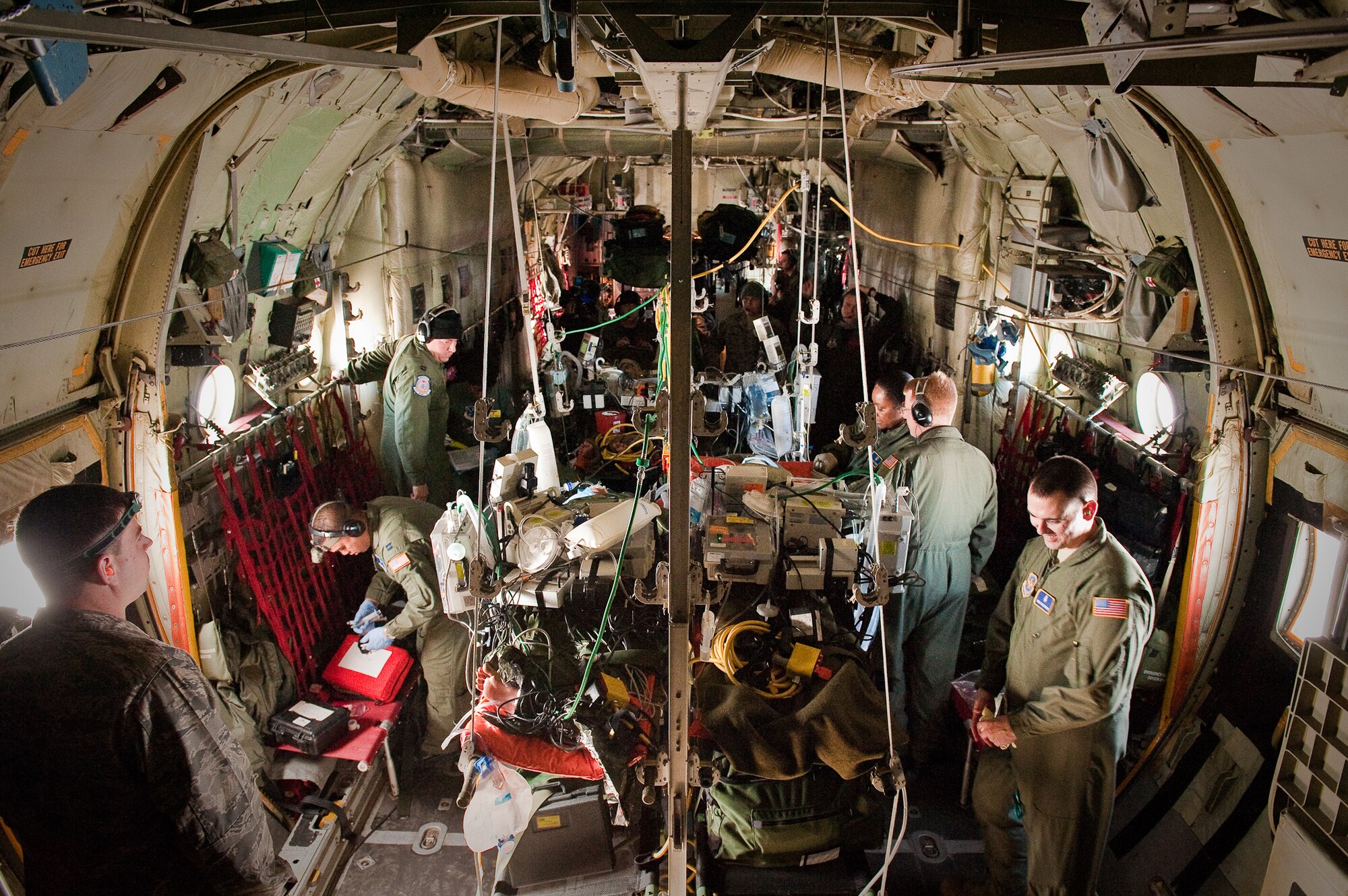 CINCINNATI, OHIO -- An airborne C-130 offers a dynamic environment for medical personnel who are training to care for simulated patients over the skies of southern Ohio on Feb 11, 2010. Aircraft movement and turbulence pose challenges to physical coordination, engine noise and earplugs make communication difficult, and patient litters consume most of the available workspace. (U.S. Air Force by Maj. Dale Greer)