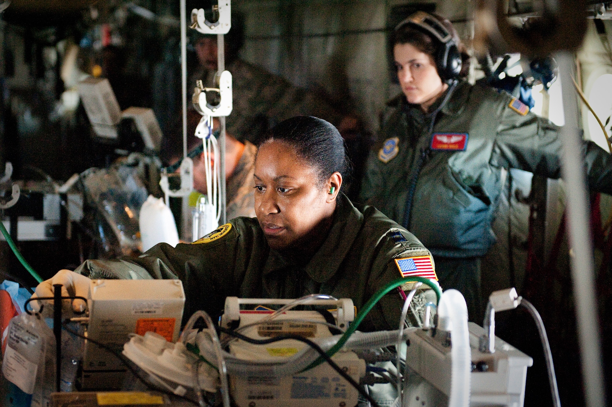 CINCINNATI, OHIO -- Capt. Marsha Starks, a nurse from the 633rd Air Base Wing at Langley Air Force Base, Va., checks a simulated patient's saline solution while airborne Feb 11, 2010, as 1st Lt. Leann Hisle, a flight nurse from 375th Aeromedical Evacuation Squadron at Scott Air Force Base, Ill., observes. Captain Starks was participating in a two-week Critical Care Air Transport Team course designed to provide medical personnel with total immersion in the care of severely injured patients. Ground training and simulated-flight training are conducted at the University of Cincinnati, one of four Air Force Centers for Sustainment of Trauma and Readiness Skills (CSTARS) nationwide, but the final day of instruction is provided while airborne in a Kentucky Air Guard C-130. Kentucky's 165th Airlift Squadron began providing C-130s to use as a CSTARS training platform in 2009. (U.S. Air Force by Maj. Dale Greer)