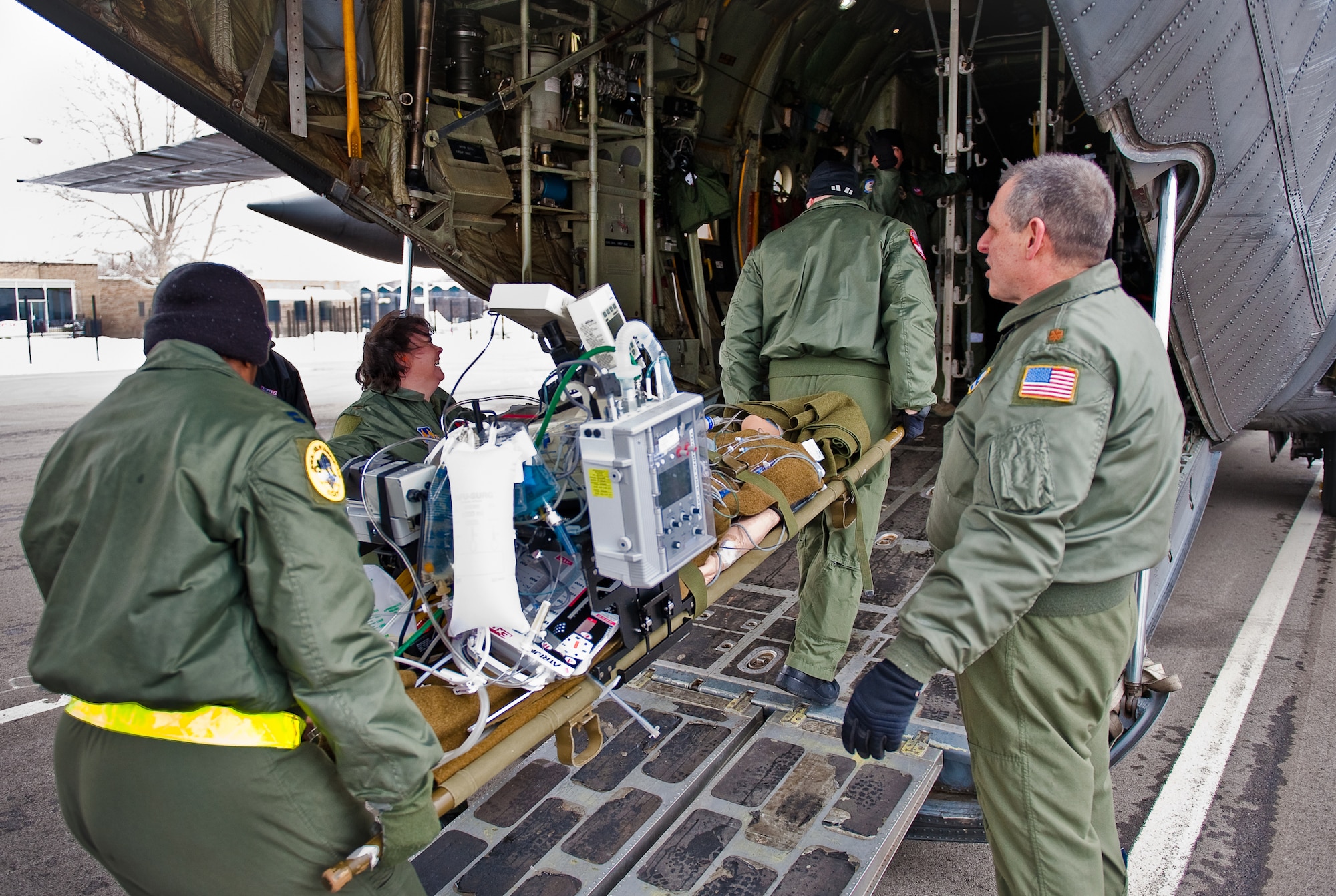 CINCINNATI, OHIO -- Students and instructors from the U.S. Air Force's CSTARS-Cincinnati course load simulated patients onto a Kentucky Air National Guard C-130 at Lunken Airport here Feb. 11, 2010. The two-week Critical Care Air Transport Team course is designed to provide medical personnel with total immersion in the care of severely injured patients. Ground training and simulated-flight training are conducted at the University of Cincinnati, one of four Air Force Centers for Sustainment of Trauma and Readiness Skills (CSTARS) nationwide, but the final day of instruction is provided during actual flight. The Kentucky Air Guard's 165th Airlift Squadron began providing C-130s to use as a CSTARS training platform in 2009. (U.S. Air Force by Maj. Dale Greer)