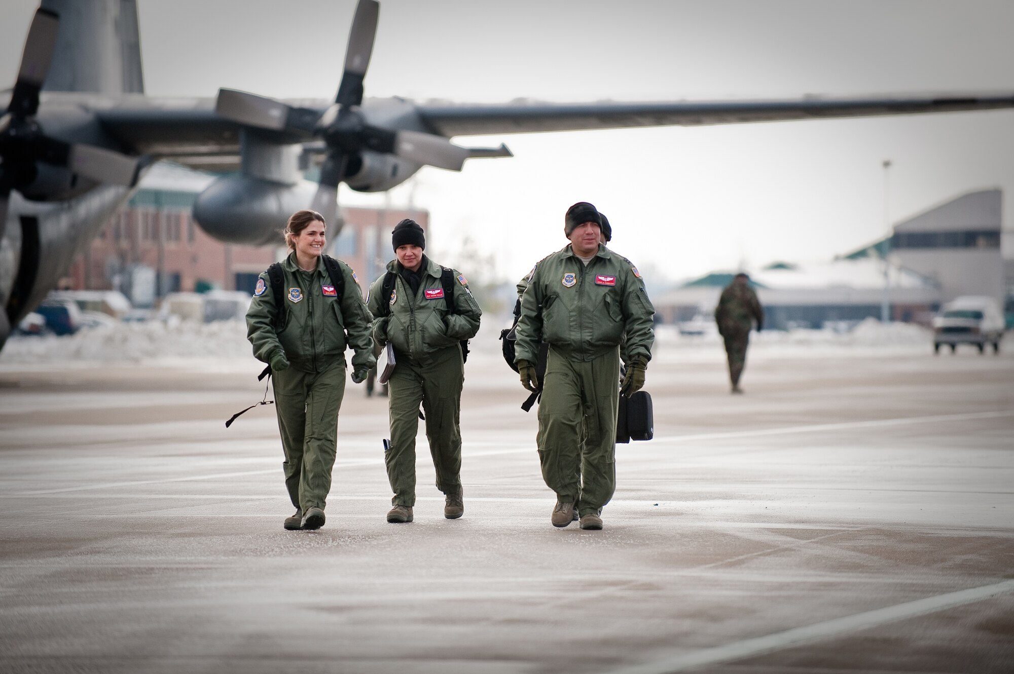 KENTUCKY AIR NATIONAL GUARD BASE, LOUISVILLE, KY. -- Members of an aeromedical evacuation team from Scott Air Force Base, Ill., prepare to board a C-130 on the flight line of the Kentucky Air National Guard Base Feb. 11, 2010. 1st Lt. Leann Hisle (left), second flight nurse; Staff Sgt. Tiffany Taylor (center), second aeromedical technician; and Capt. John Camacho, flight nurse instructor, will reconfigure the aircraft for aeromedical simulations to be conducted over the skies of southern Ohio as part of a U.S. Air Force Critical Care Air Transport Team training course. The Airmen, all assigned to the 375th Aeromedical Evacuation Squadron, also will provide aeromedical evacuation support for six students scheduled to participate in the course. (U.S. Air Force by Maj. Dale Greer)