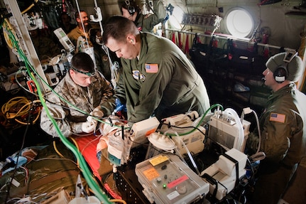 Maj. Samuel AiKele (left), an anesthesiologist from the 99th Medical Group at Nellis Air Force Base, Nev., and Master Sgt. James Woods, a respiratory therapist from the 60th Surgical Operations Squadron at Travis Air Force Base, Calif., perform cardio-pulmonary resuscitation on a medical-training mannequin. The Airmen were participating in a two-week Critical Care Air Transport Team course at the University of Cincinnati Center for Sustainment of Trauma and Readiness Skills, Feb. 11, 2010. The course provides medical personnel total immersion in the care of severely injured patients in-flight. (U.S. Air Force by Maj. Dale Greer)