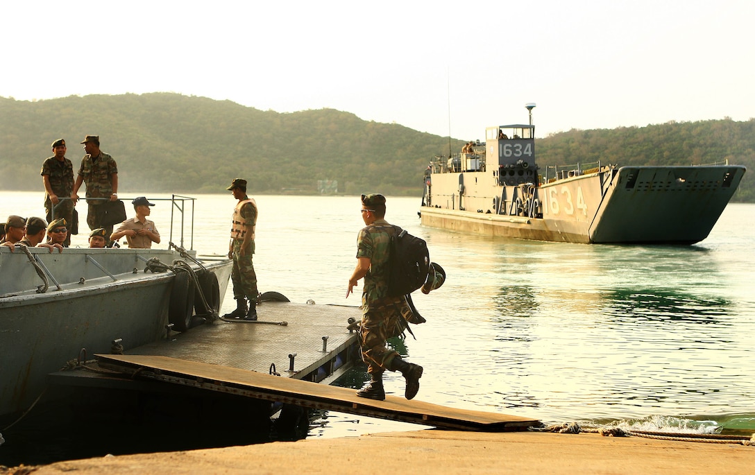 Royal Thai Marines board a Thai naval vessel as a landing craft utility (LCU) transporting Marines, sailors and vehicles with the 31st Marine Expeditionary Unit (MEU), approaches the shore, Feb. 1. The MEU is currently in the offload phase in support of exercise Cobra Gold 2010 (CG’ 10). The exercise is the latest in a continuing series of exercises design to promote regional peace and security.